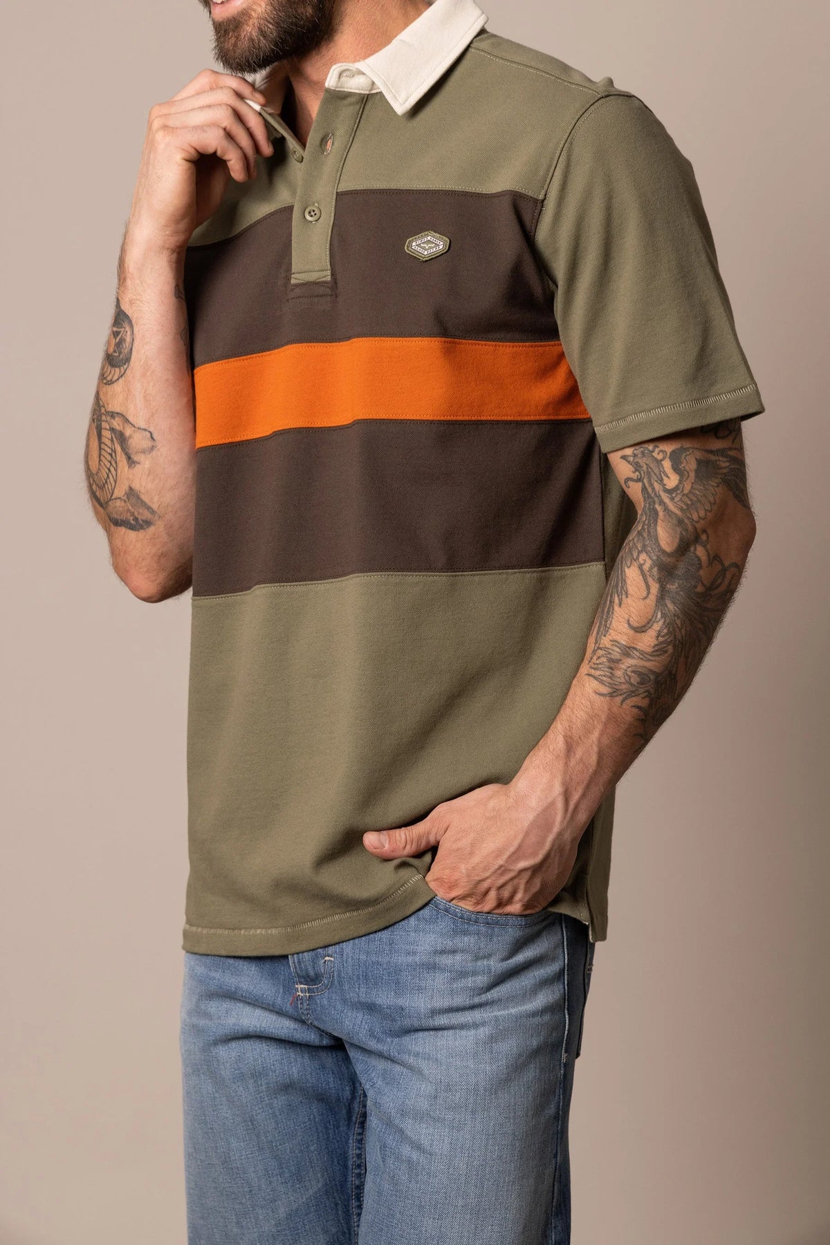 Kimes Ranch 1874 Polo in Army Green, side view, with brown and orange horizontal stripes and a cream collar