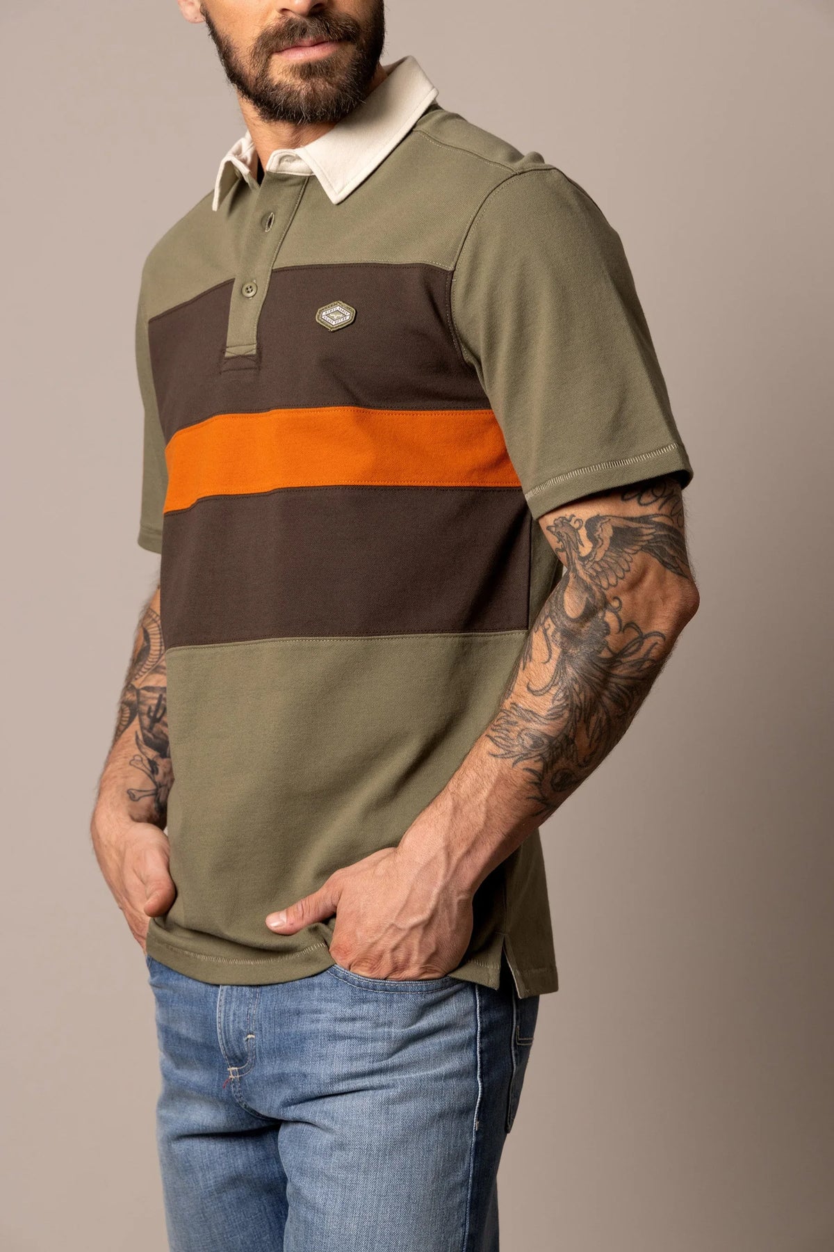Kimes Ranch 1874 Polo in Army Green, side view, with brown and orange horizontal stripes and a white collar