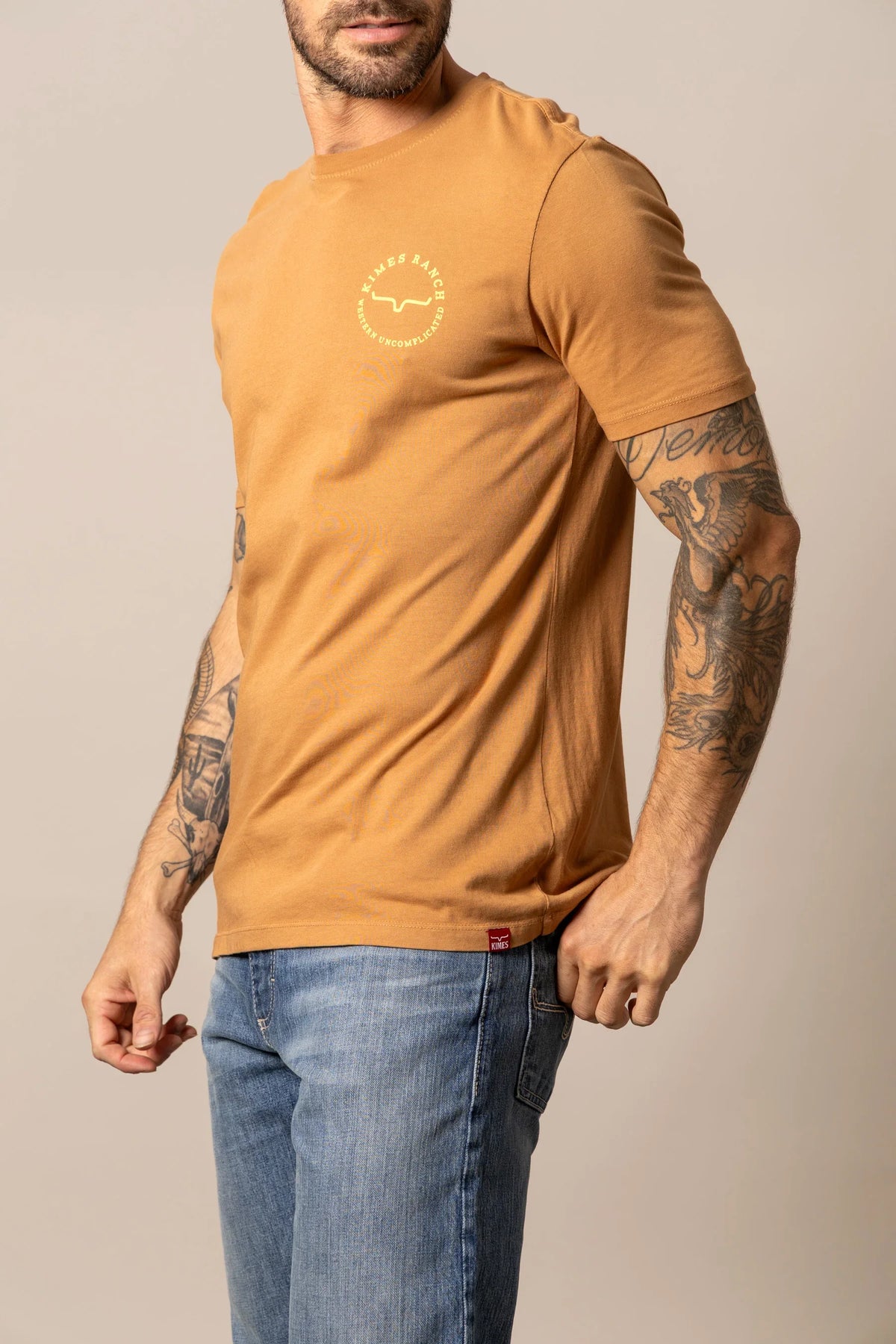 Kimes Ranch 1956 shirt in Work Wear Brown, side view, with a chest logo and short sleeves