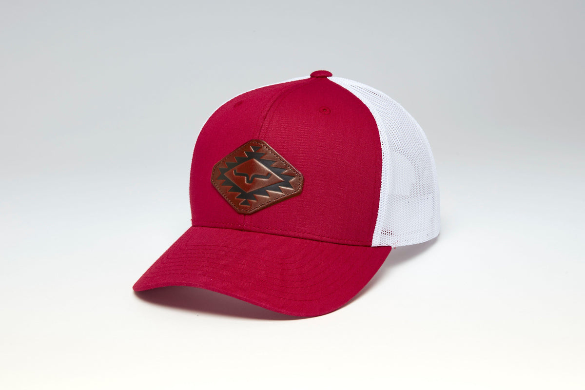 Kimes Ranch San Juan hat in Rust Red, side view, with a brown logo patch on the front and white mesh back