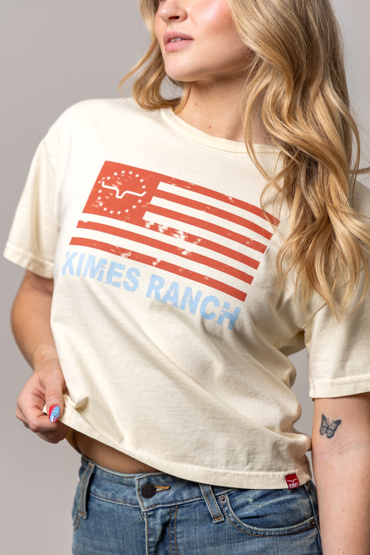 Kimes Ranch 76 shirt in Ivory with a distressed red flag graphic and blue Kimes Ranch text