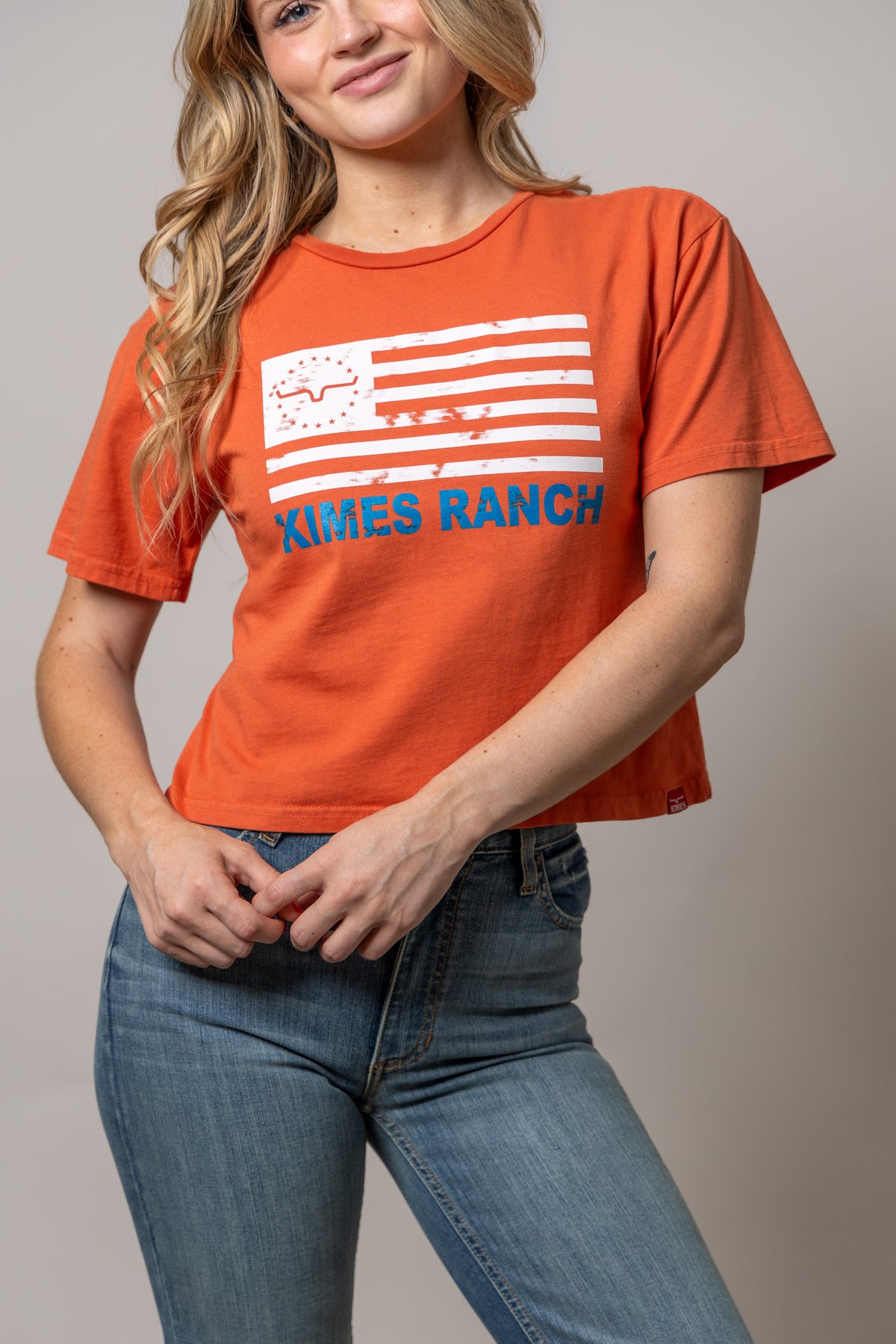 Kimes Ranch 76 Spice Red short sleeve shirt with distressed flag graphic and blue Kimes Ranch text