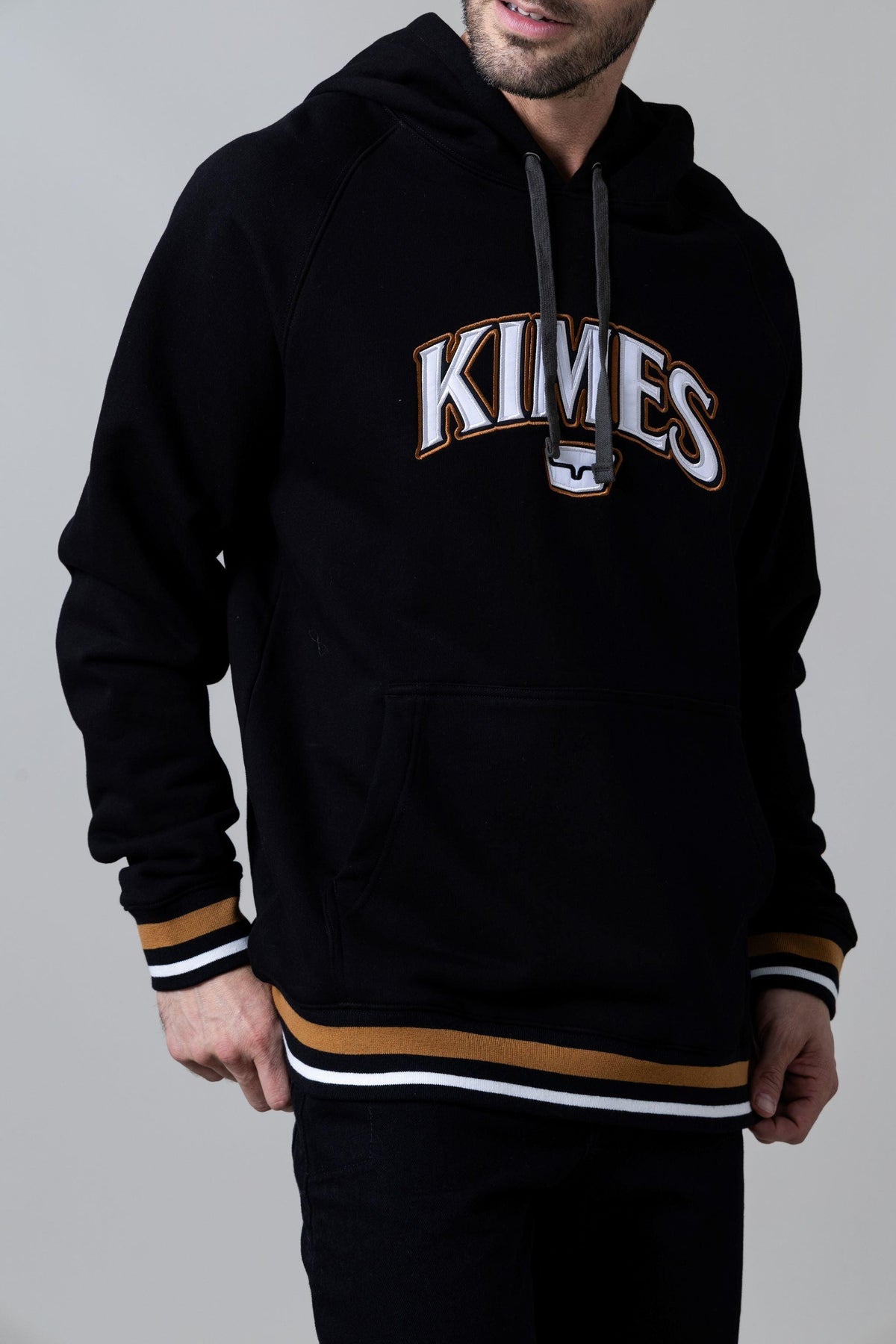 Kimes Ranch Kubo Hoodie in Black with KIMES logo and gold and white striped cuffs