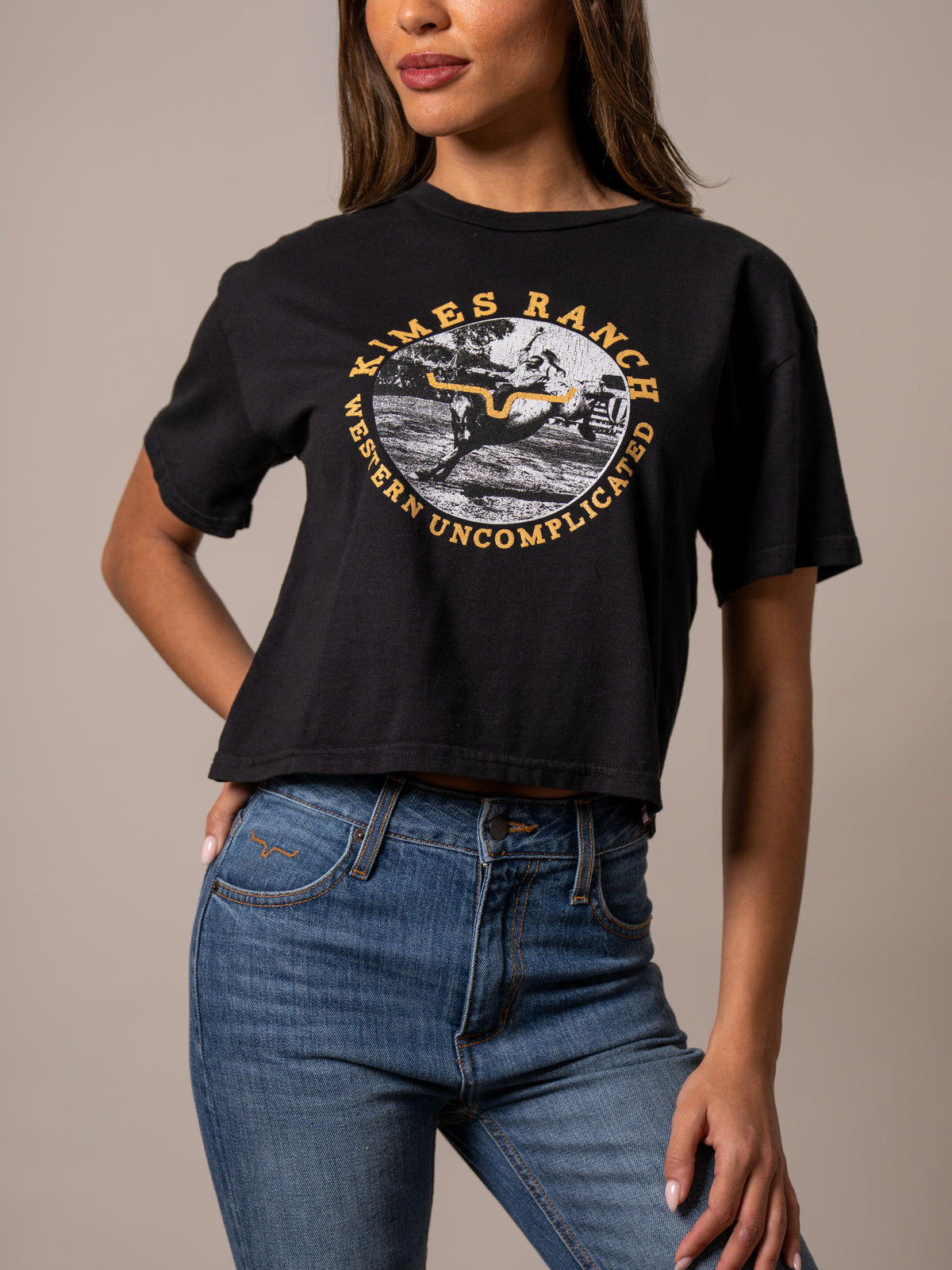 Kimes Ranch Afternoon Rodeo Black shirt with a graphic of a cowboy on a bucking horse and the text Western Uncomplicated