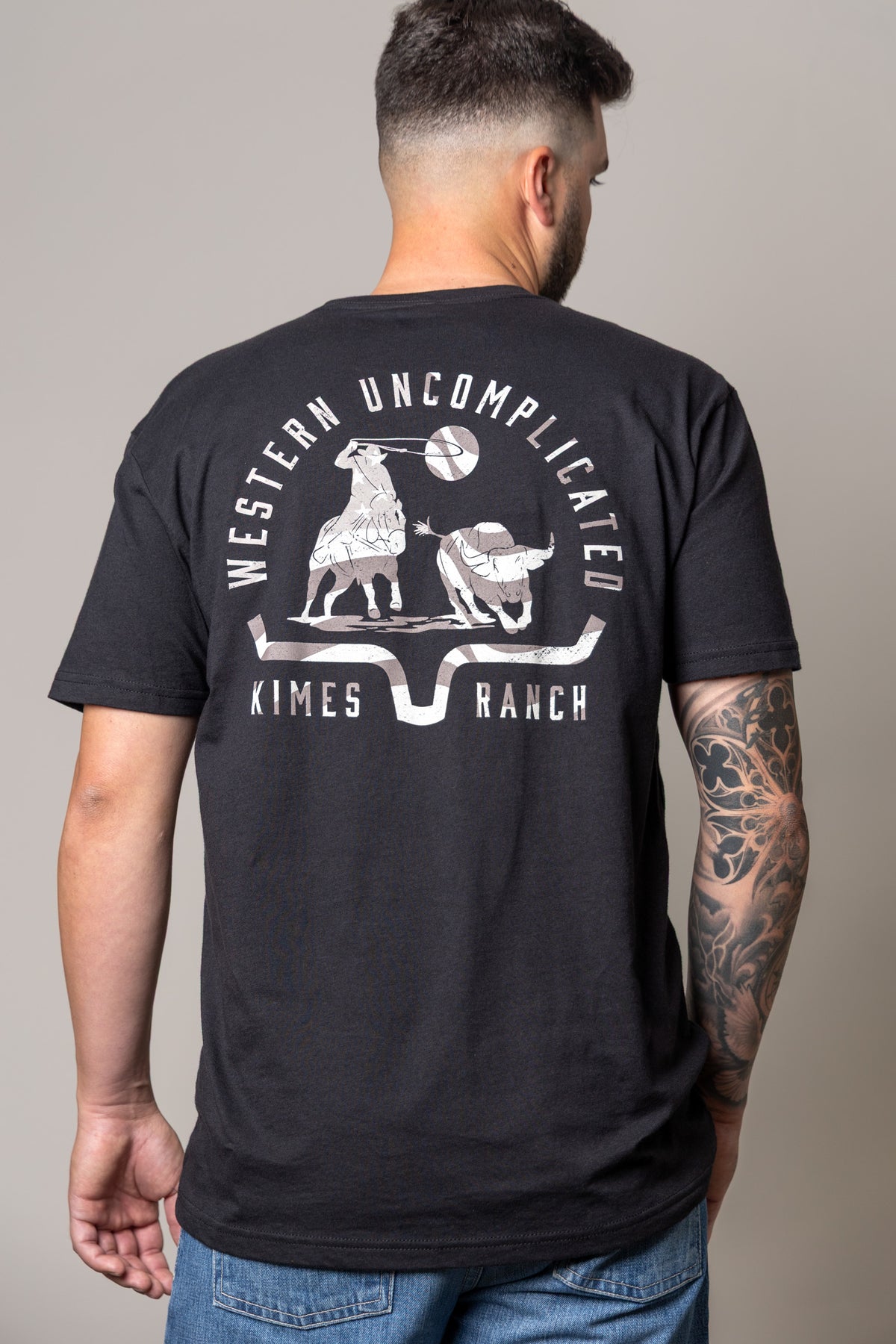Kimes Ranch American Cowboy shirt in Black, back view, with a back graphic of a cowboy roping a steer