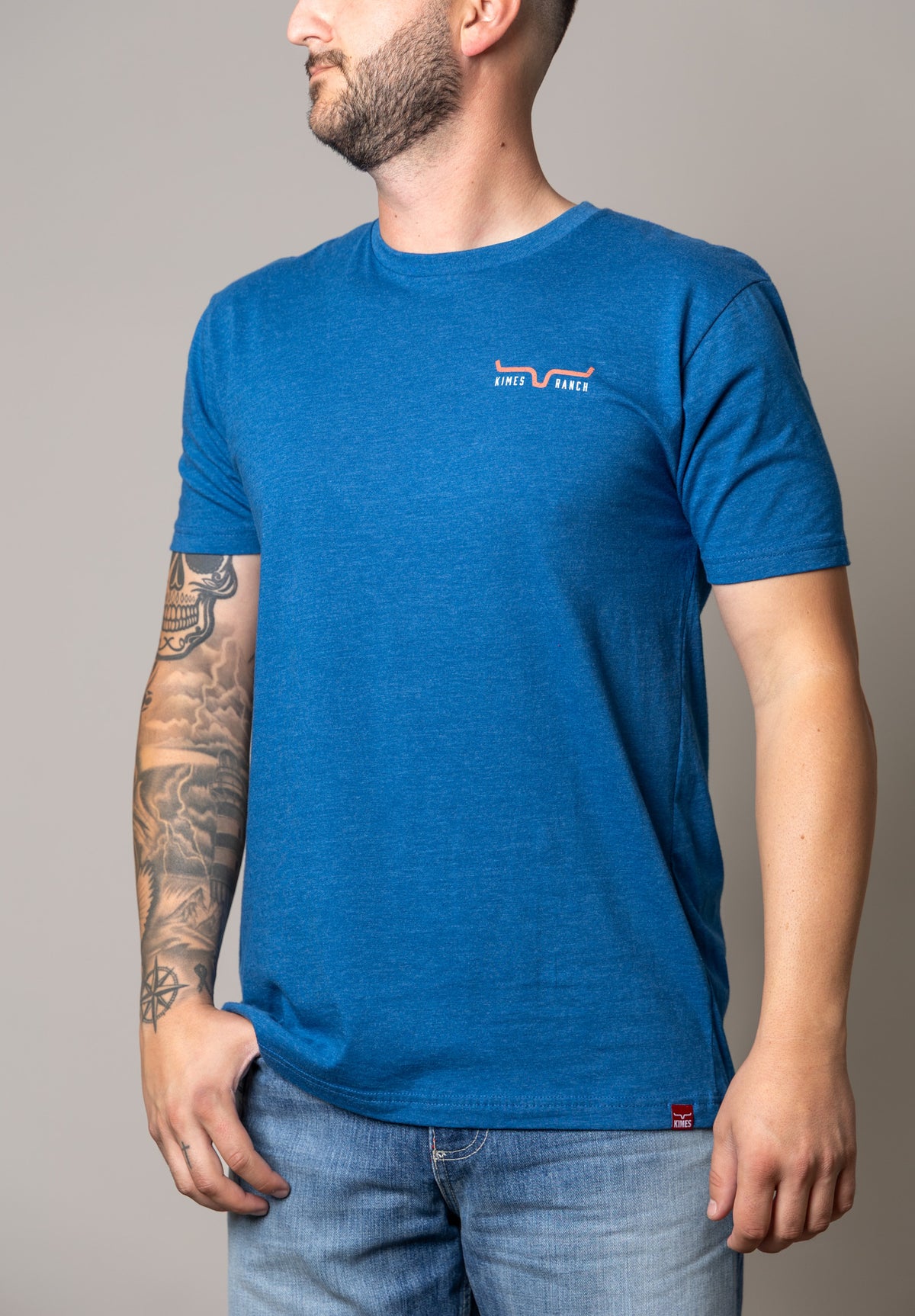 Kimes Ranch American Cowboy shirt in Heather Cool Blue, side view, with a chest logo and side tag