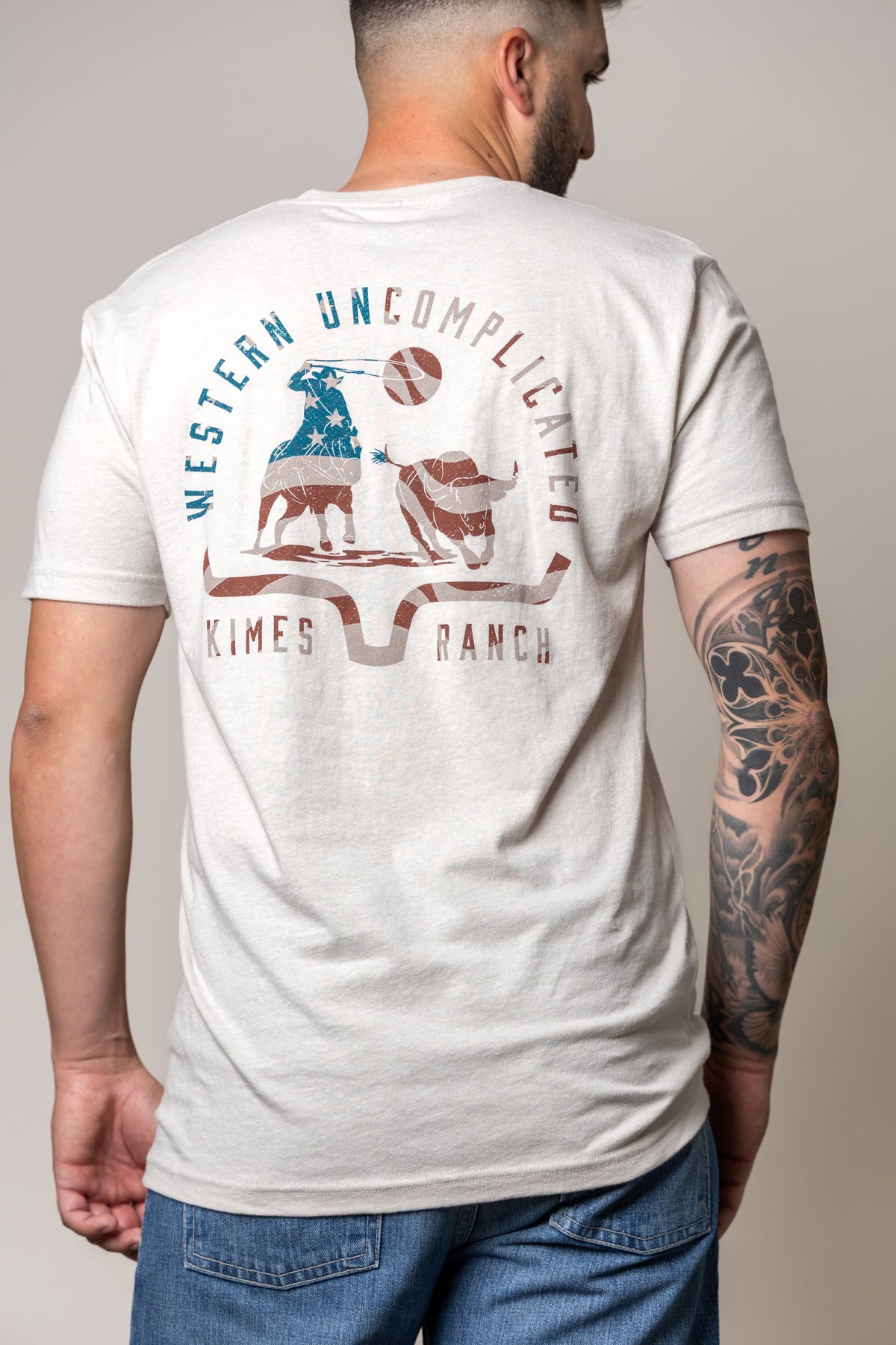 Kimes Ranch American Cowboy shirt in Sand, back view, with a back graphic of a cowboy and steer