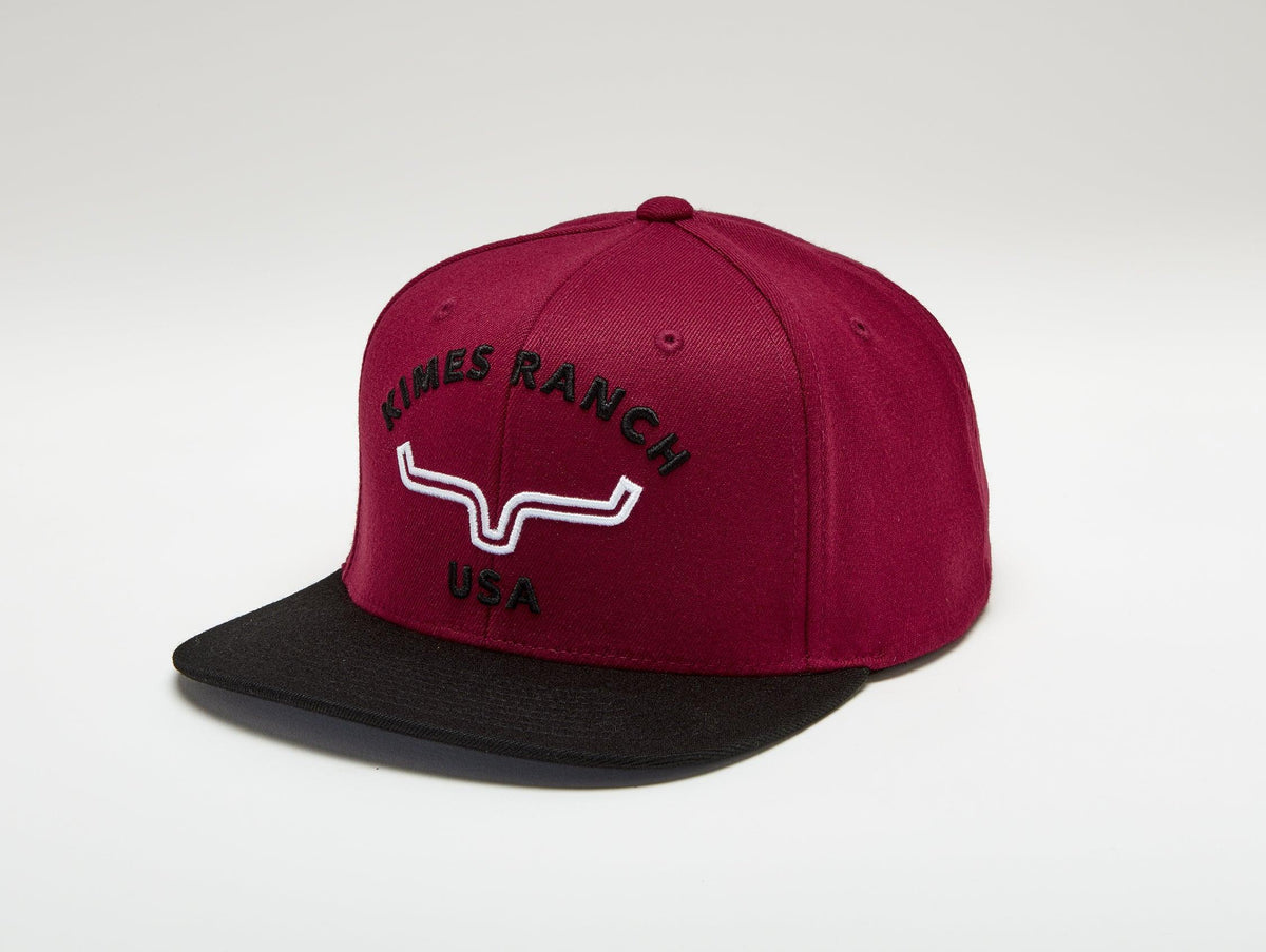 Kimes Ranch Arched Trucker Hat in Dark Red with a black brim and embroidered logo