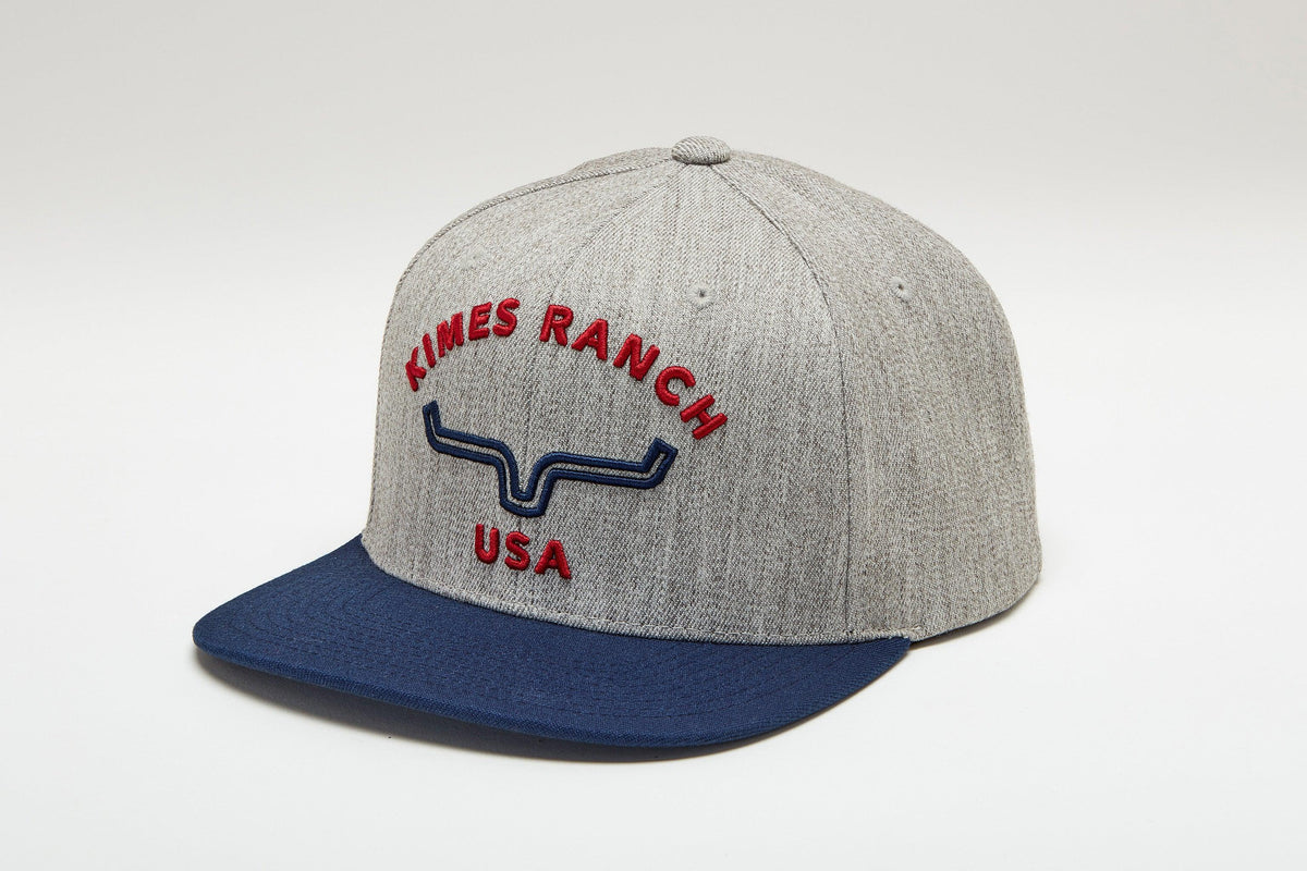 Kimes Ranch Arched Trucker Hat in Grey Heather, side view, with navy brim and red embroidered logo