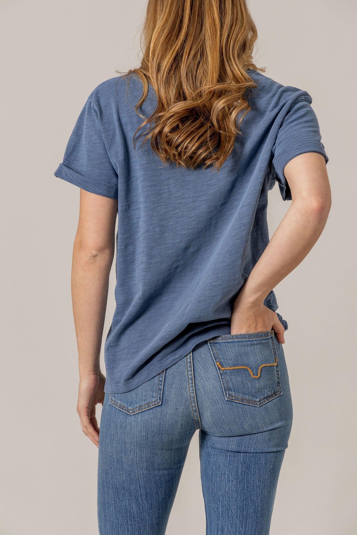 Kimes Ranch Ashley Tee in Blue, back view, with rolled short sleeves and a relaxed fit