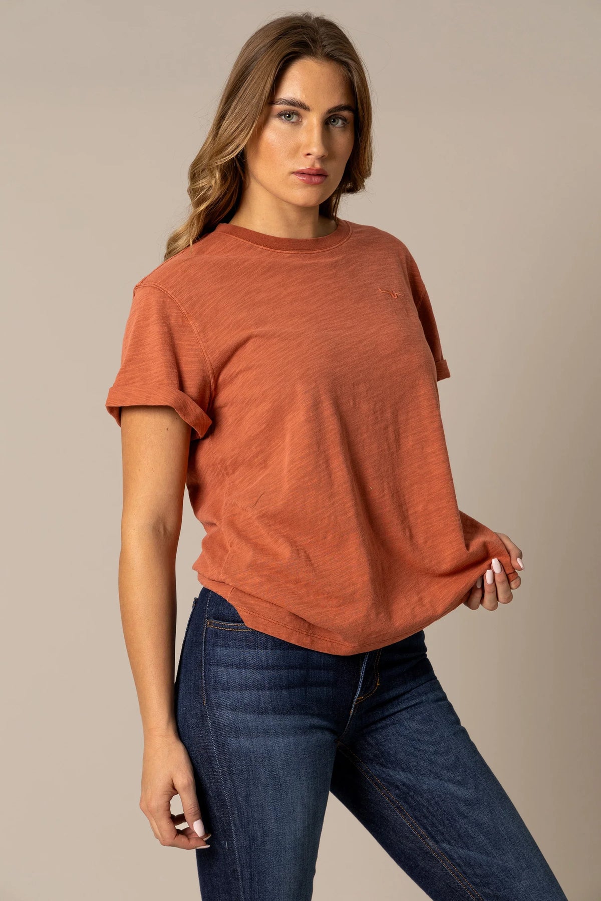 Kimes Ranch Ashley Tee in Burnt Red, side view, with rolled short sleeves and a small embroidered logo on the chest