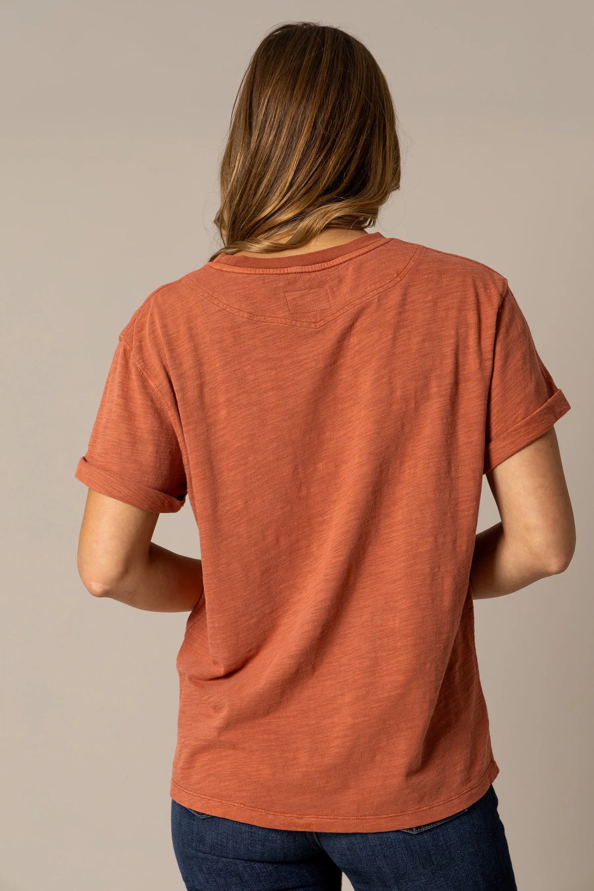 Kimes Ranch Ashley Tee in Burnt Red, back view, with rolled short sleeves and a back yoke detail