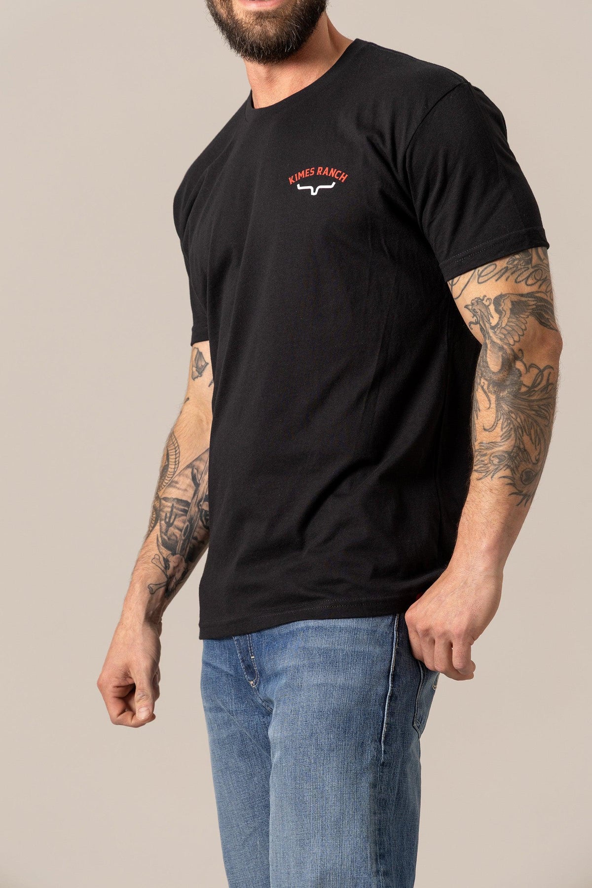 Kimes Ranch Bandera Tee in Black, side view, with a chest logo and short sleeves