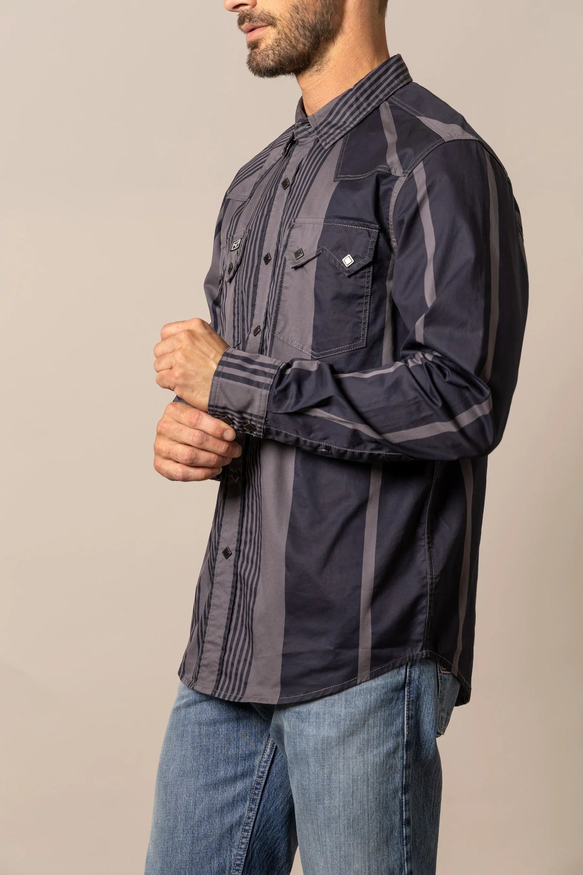 Kimes Ranch Bandit dress shirt in Black, side view, with grey vertical stripes and chest pockets