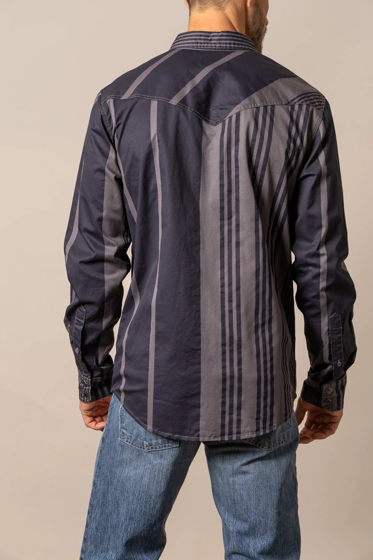 Kimes Ranch Bandit dress shirt in Black, back view, with contrasting grey paneling and vertical stripes on the back