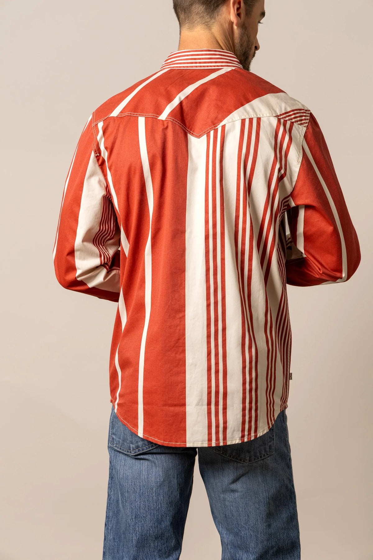 Kimes Ranch Bandit dress shirt in Brick Red, back view, with white vertical stripes and a yoke