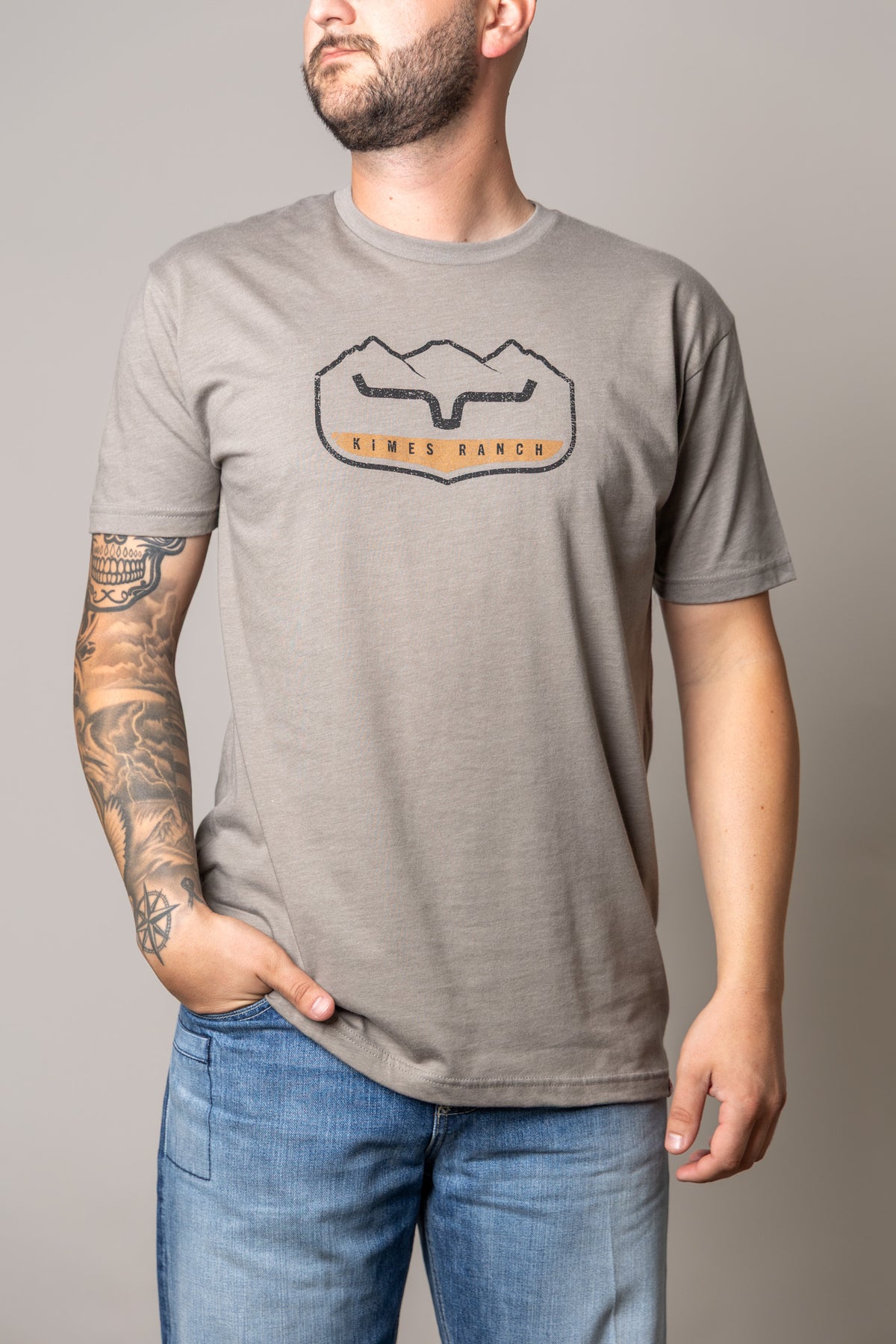 Kimes Ranch Banquet shirt in Stone with a front graphic featuring the Kimes Ranch logo and mountains