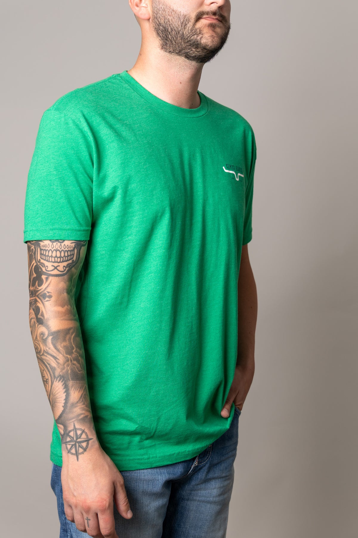 Kimes Ranch Bar Doors shirt in Kelly Green, side view, with a crew neck and short sleeves and a small logo on the chest
