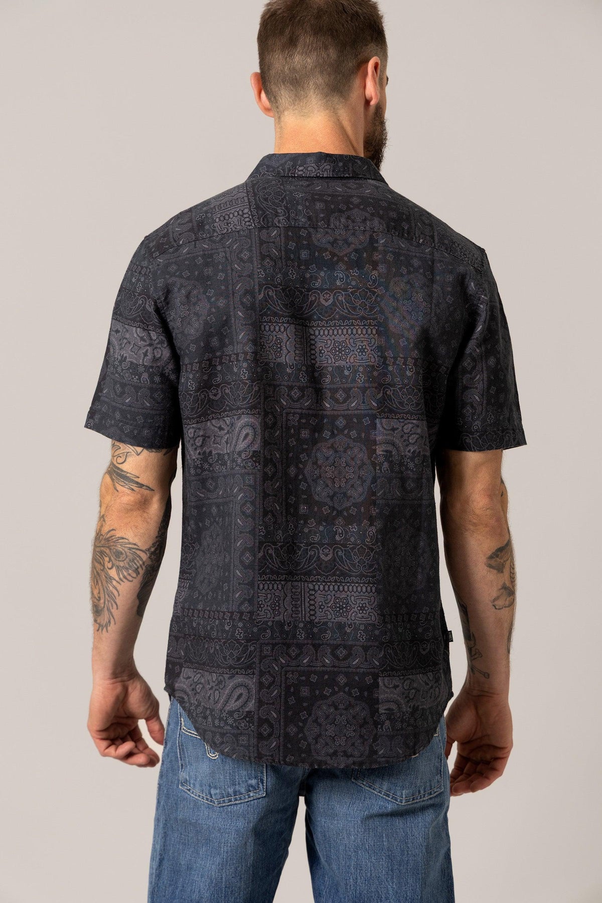 Kimes Ranch Barrett Button Up dress shirt in Black, back view, with a patchwork bandana print