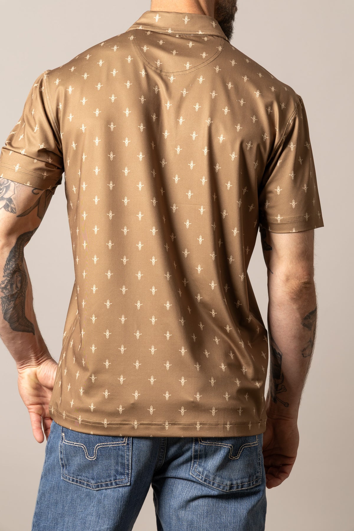 Kimes Ranch Bartram polo shirt in Brown, back view, with an all-over white Kimes Ranch logo print and a back yoke
