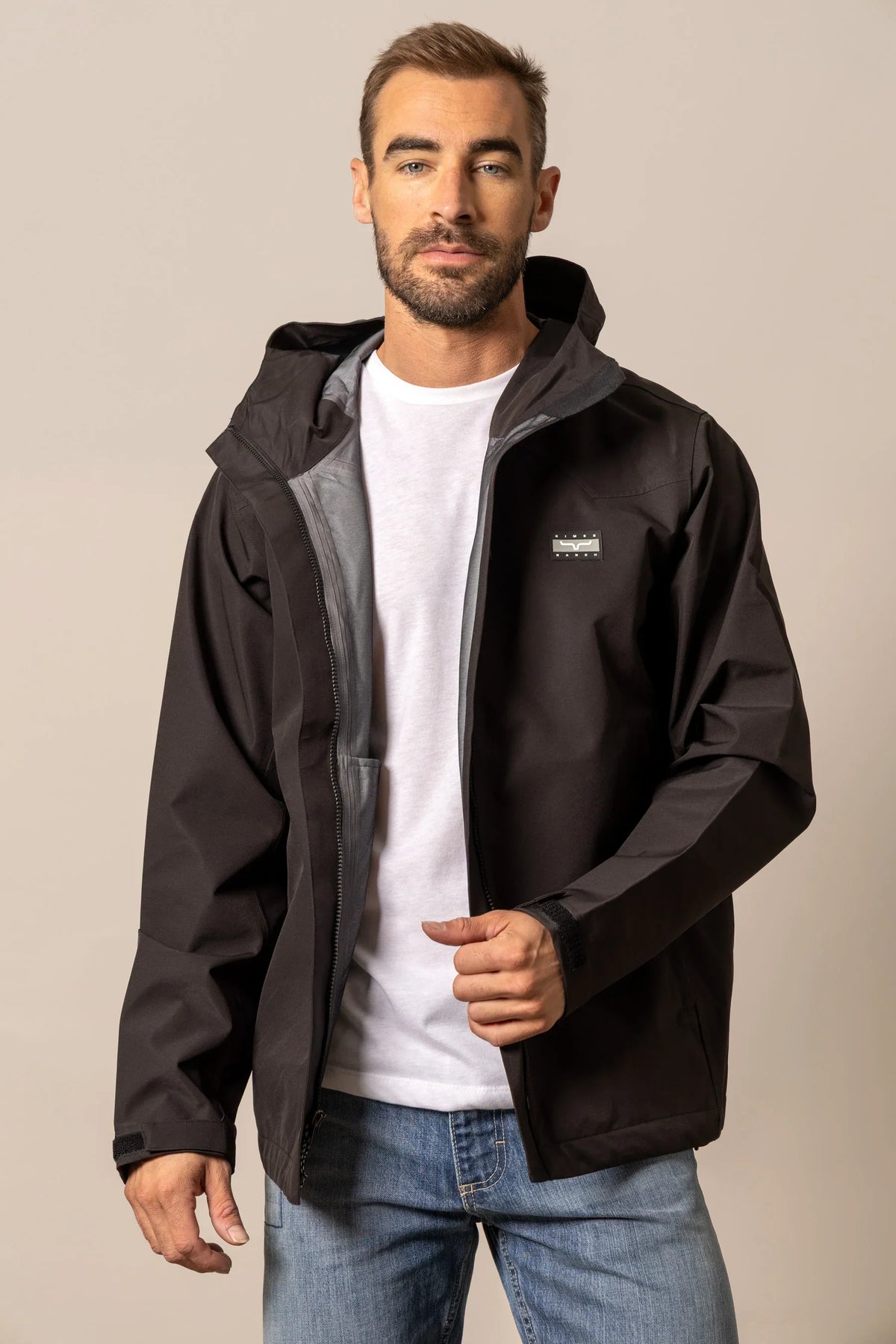 Kimes Ranch Beartooth Shell jacket in Black with a hood and logo on the chest
