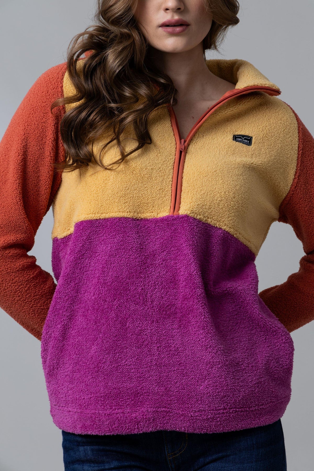 Kimes Ranch Roswell Polar Fleece sweatshirt in Burnt Orange with mustard and purple color blocking and a half-zip front