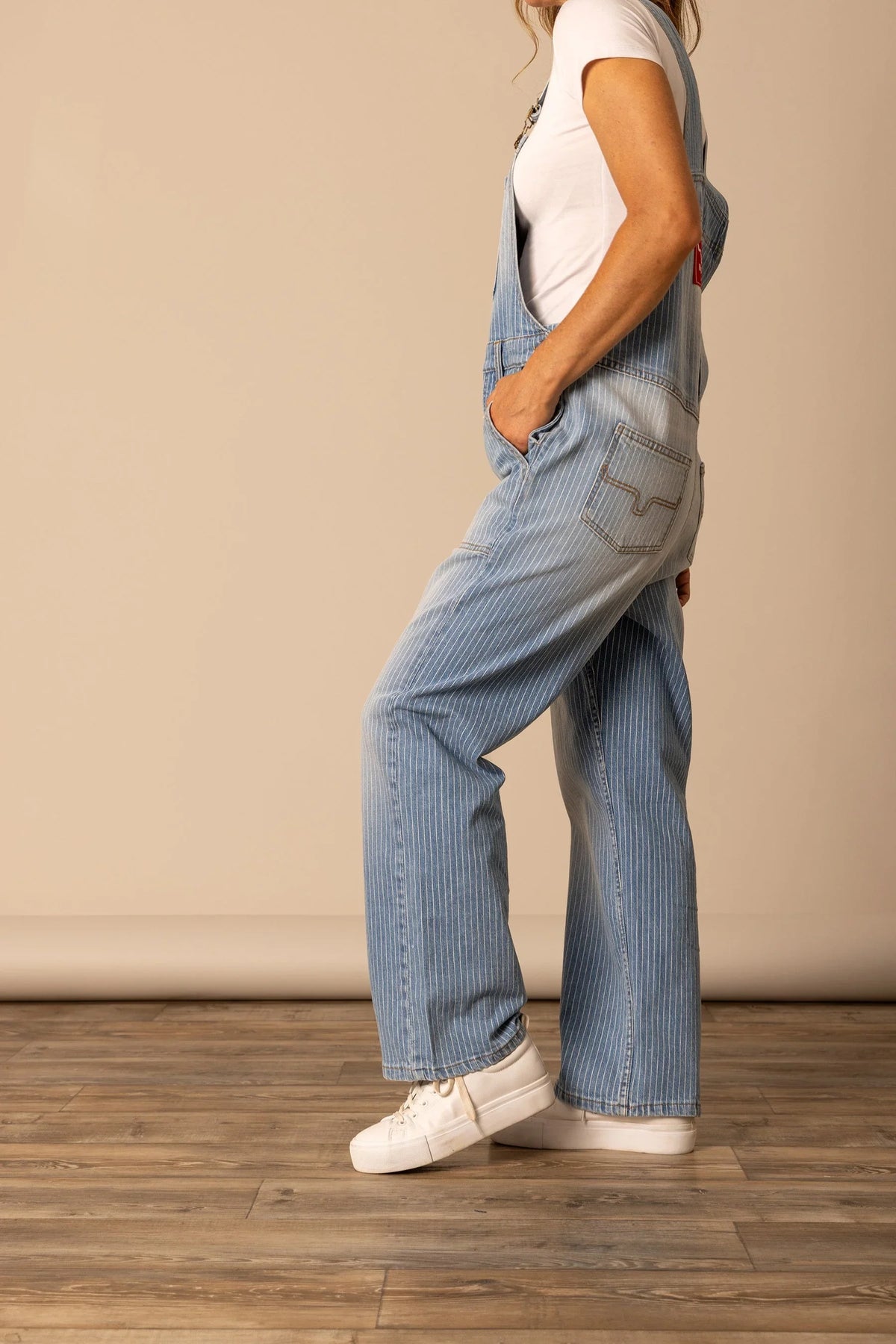 Kimes Ranch Billy Overalls, side view, in Stripe with a wide leg and back pocket