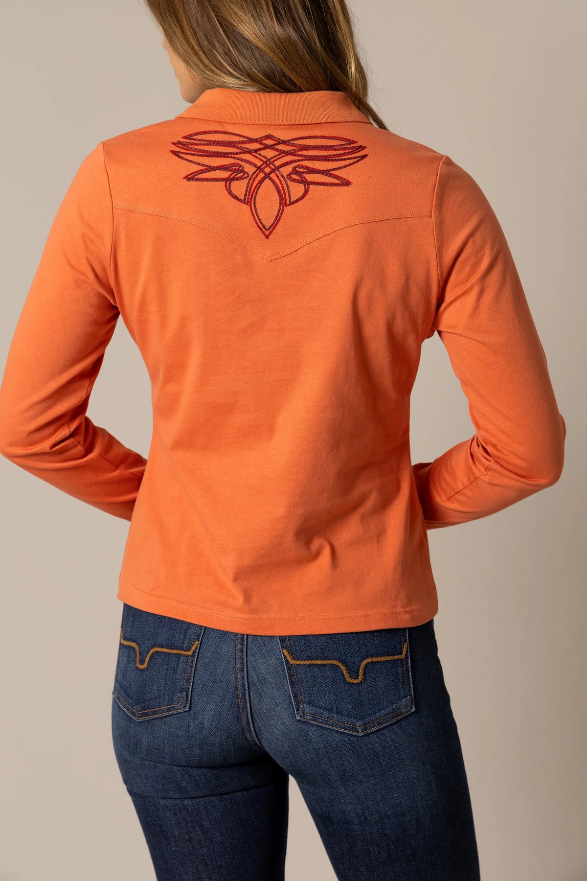 Kimes Ranch Bluebell top in Muted Red, back view, with long sleeves and a western yoke featuring the Kimes Ranch logo