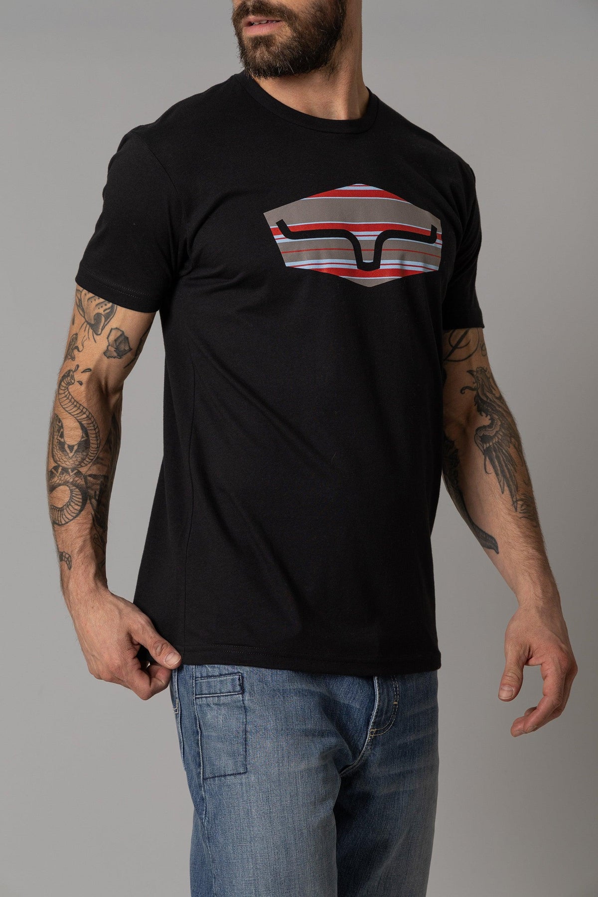 Kimes Ranch Box Seats Striped shirt in Black with a graphic of a stylized Kimes Ranch logo in red, white, and grey stripes