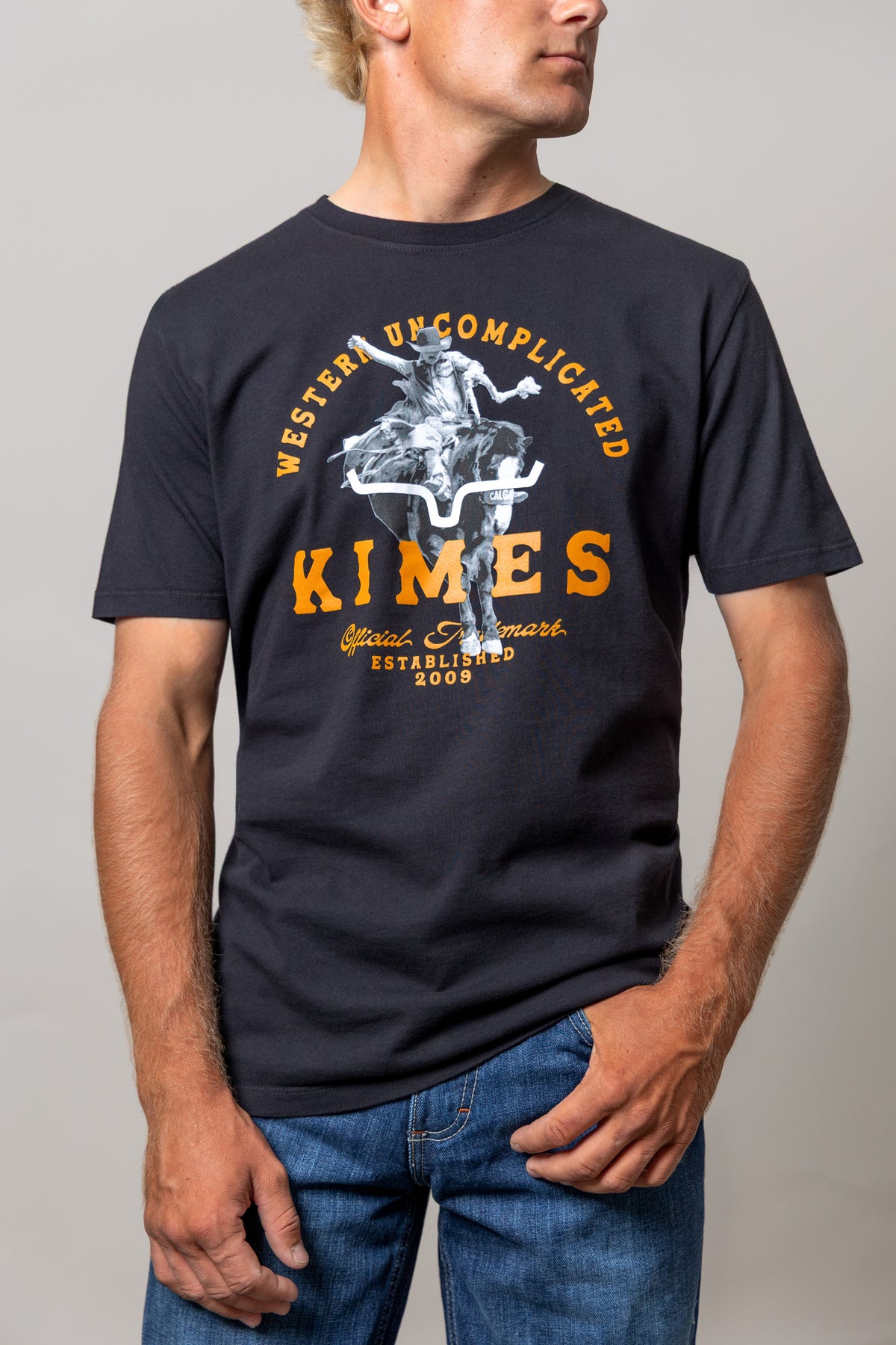 Kimes Ranch Break Through shirt in Black with a cowboy riding a horse and Western Uncomplicated Kimes text