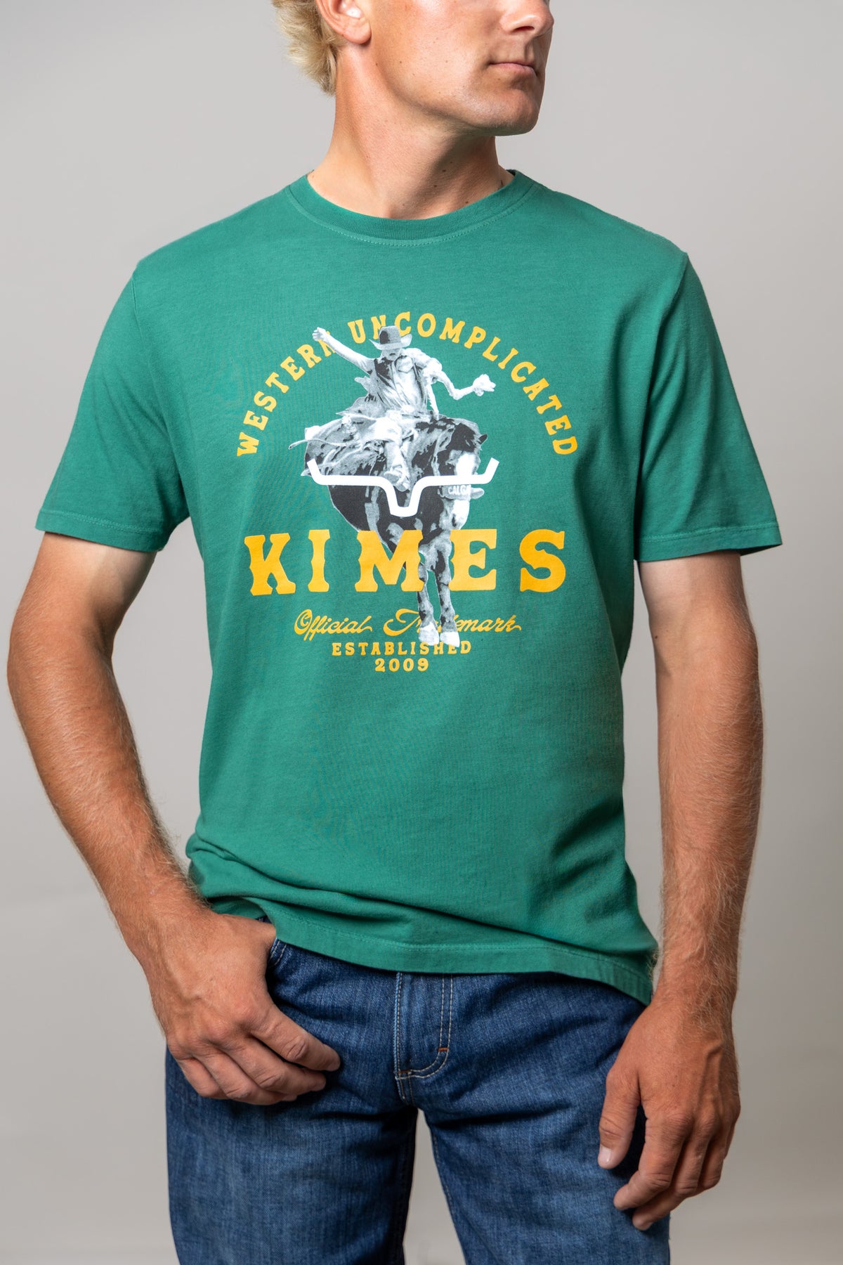 Kimes Ranch Break Through shirt in Green with a cowboy riding a longhorn graphic and Western Uncomplicated text
