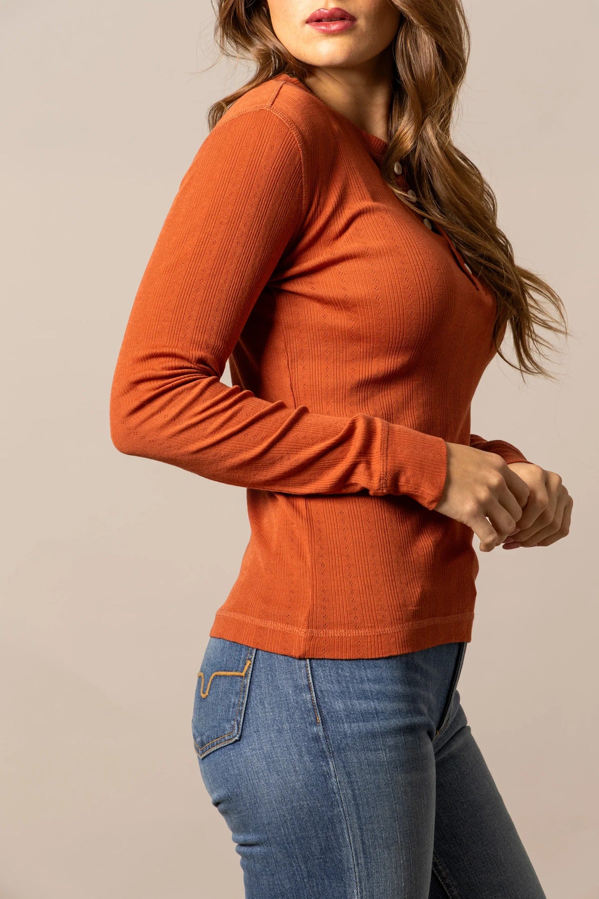 Kimes Ranch Bree Henley in Burnt Red, side view, with long sleeves and a ribbed knit texture
