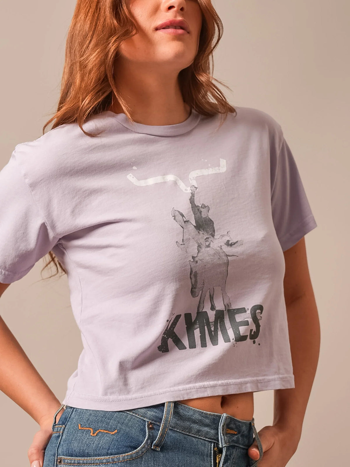 Kimes Ranch Bucks shirt in Lavender with a graphic of a cowboy on a bucking horse and the word KIMES