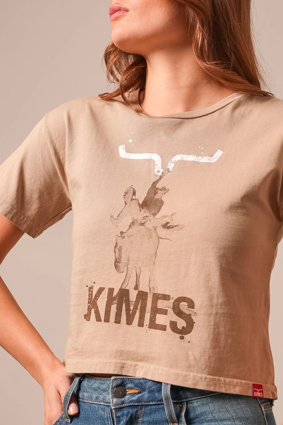 Kimes Ranch Bucks shirt in Tan with a graphic of a cowboy on a bucking horse and the word KIMES