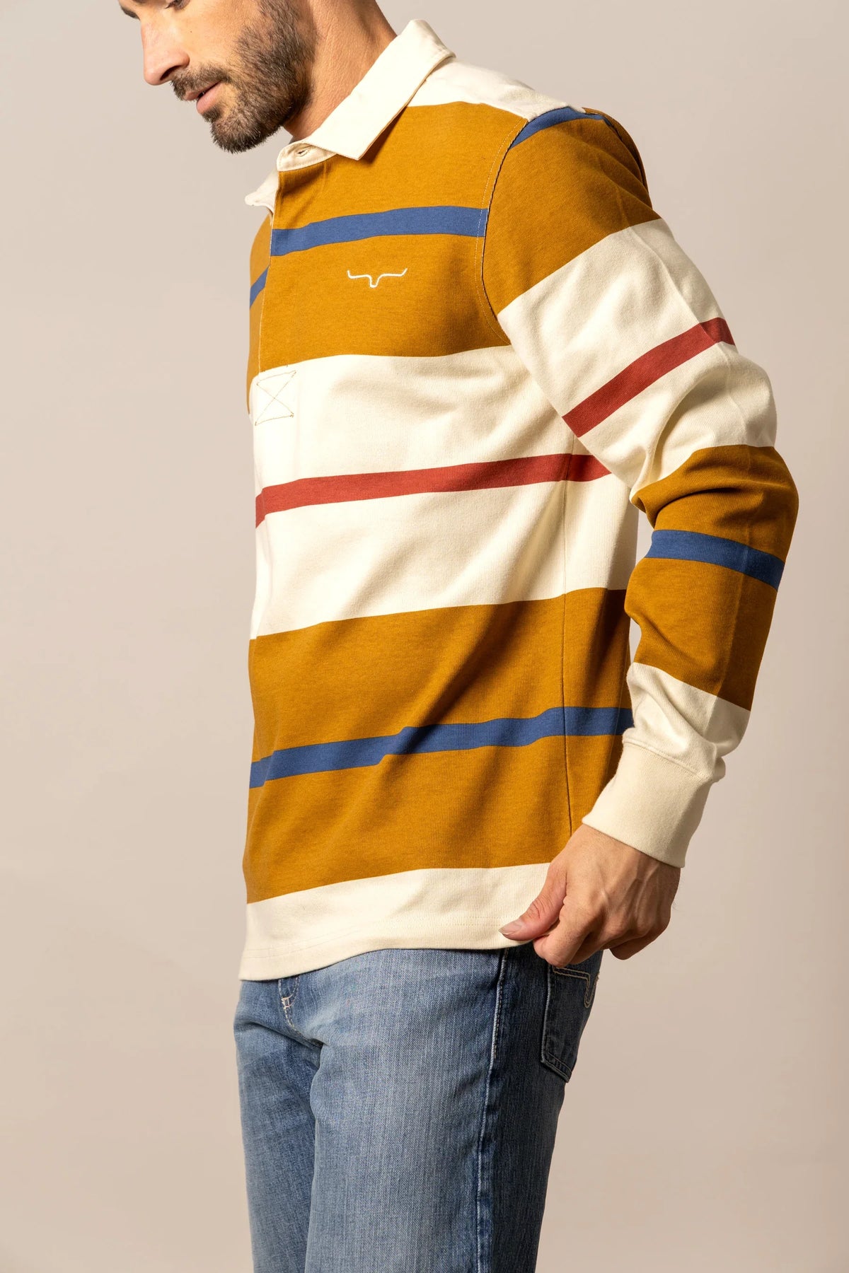 Kimes Ranch Bulldog Rugby polo in Work Wear Brown, side view, with wide cream, blue and red horizontal stripes