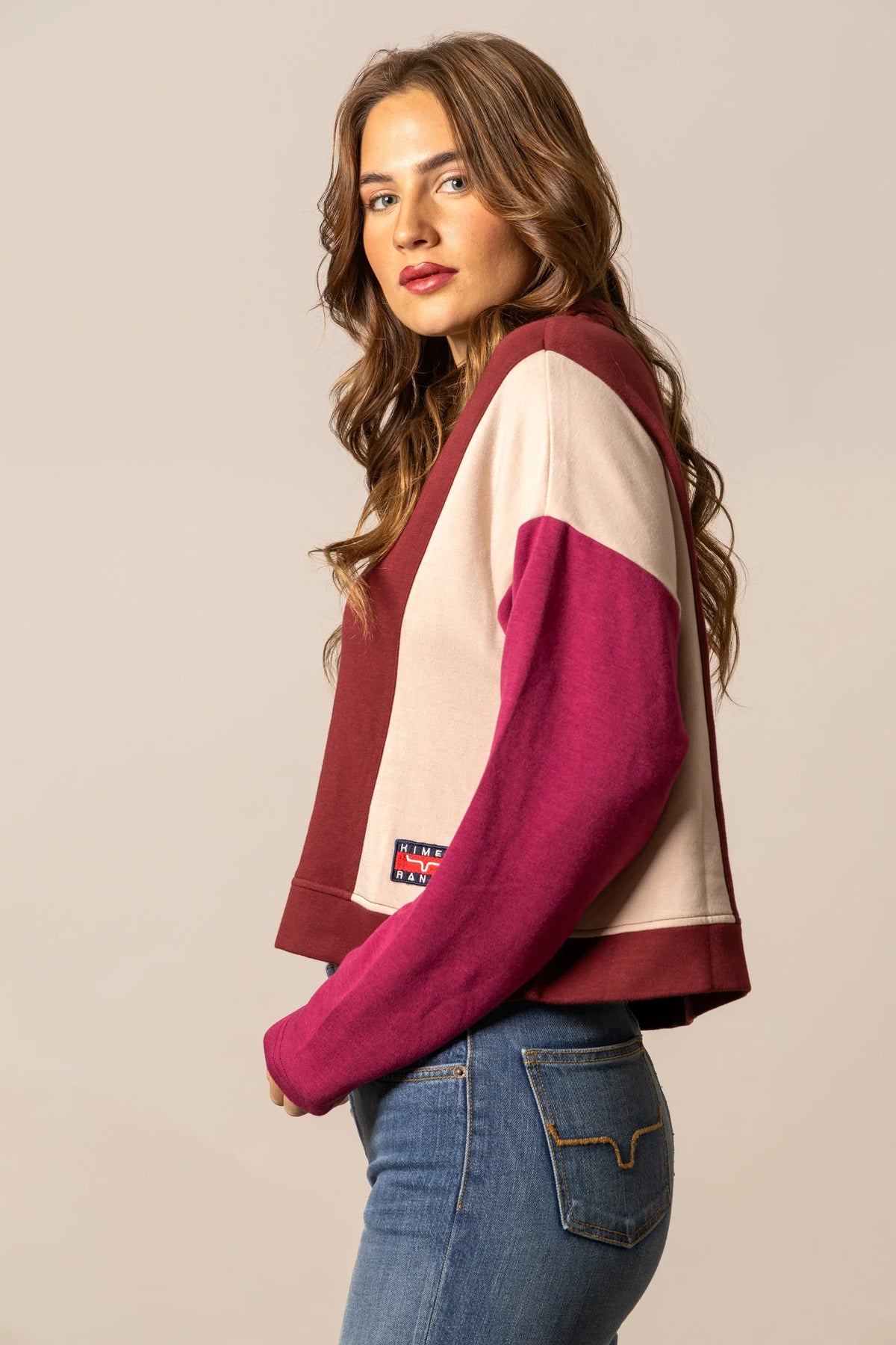 Kimes Ranch Cami Sweater in Maroon, side view, with colorblocked sleeves and a logo patch