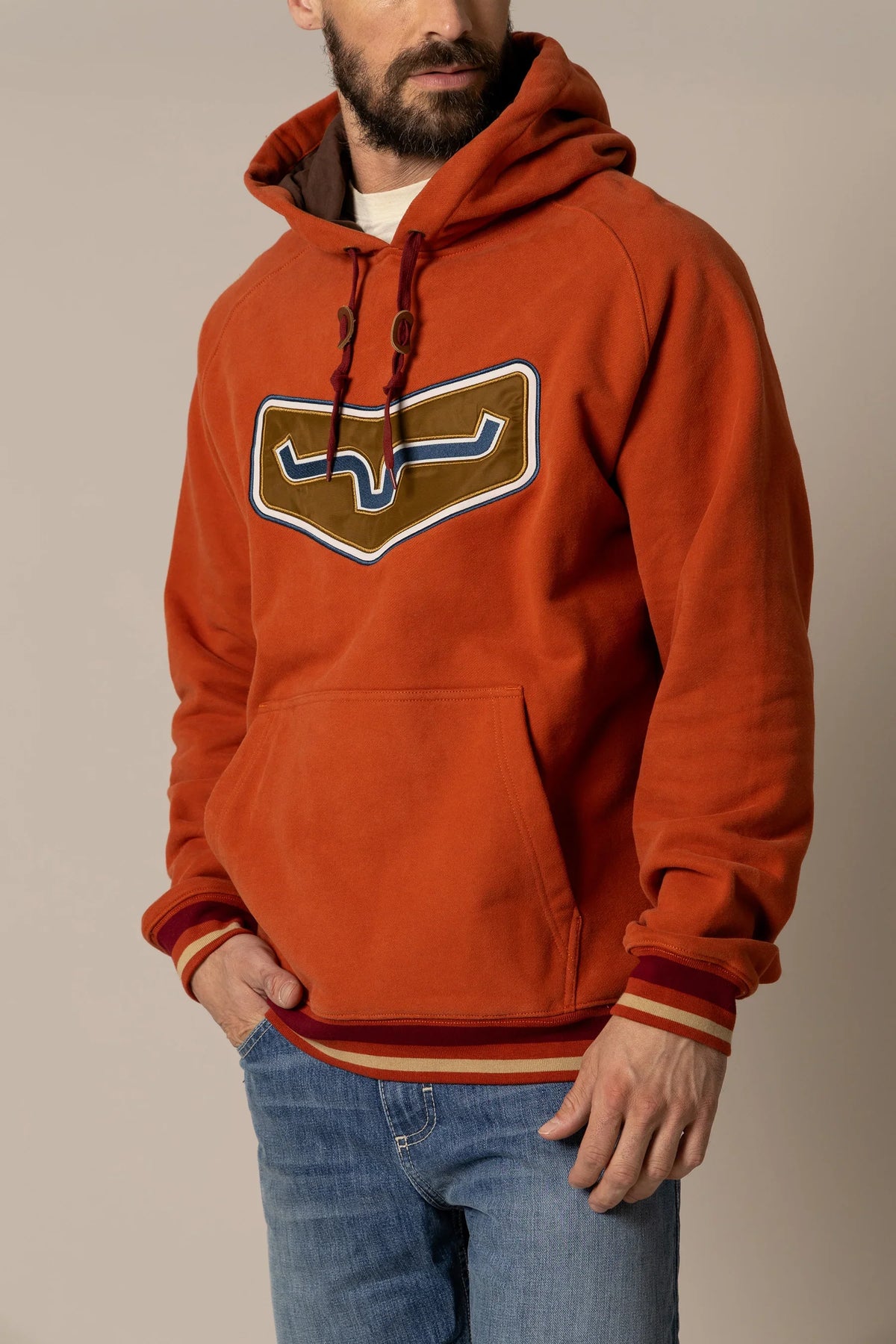 Kimes Ranch Cannons Hoodie in Brick Red with a large chest graphic and striped cuffs