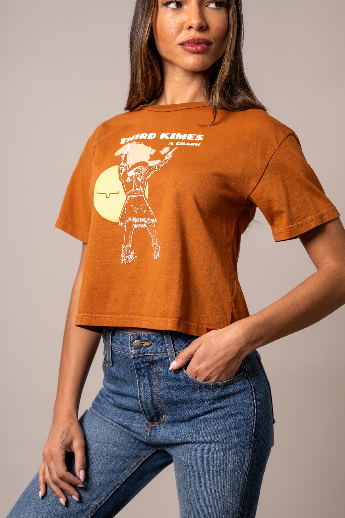 Kimes Ranch Charming shirt in Rust with a white graphic of a cowgirl and the text Third Kimes A Charm