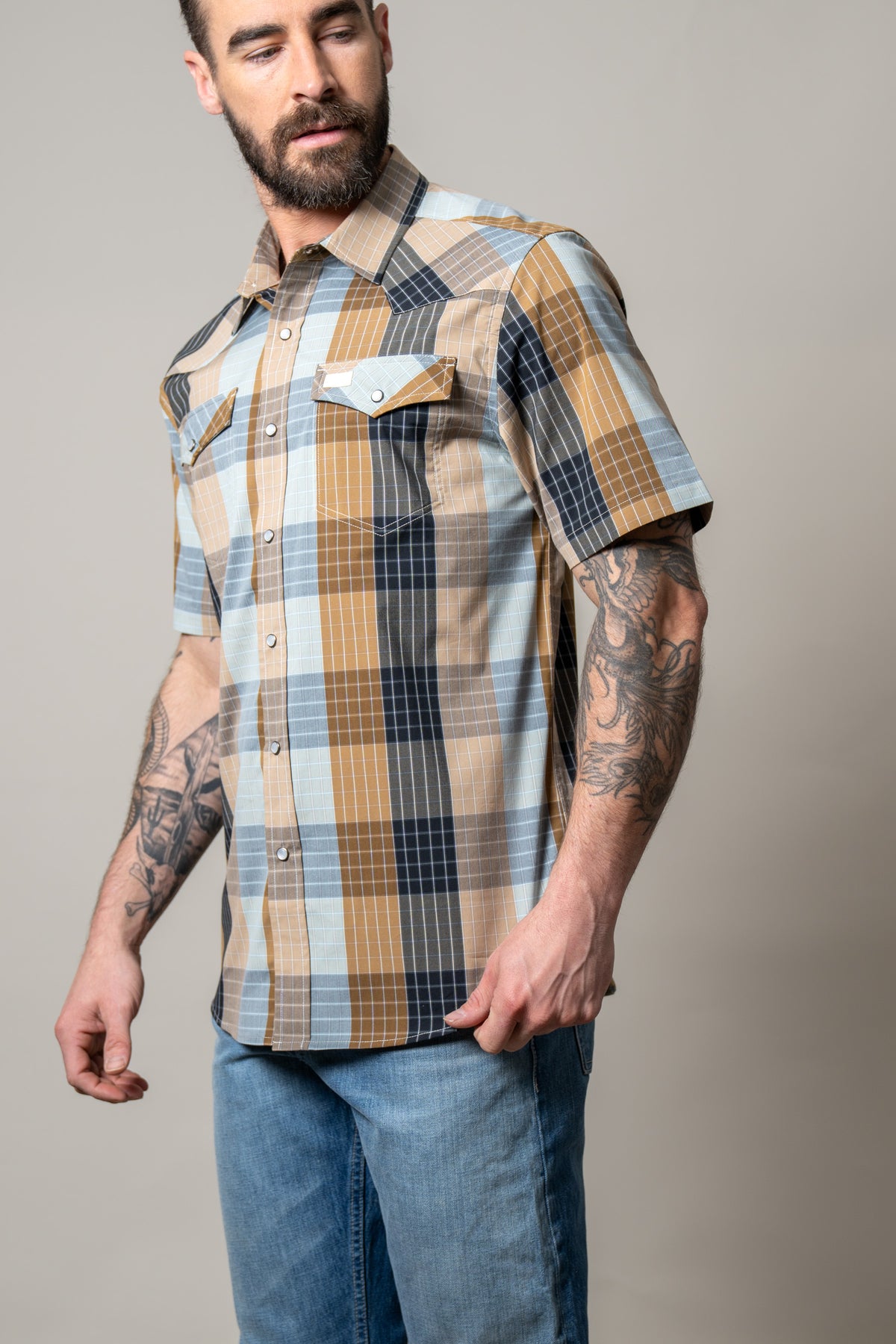 Kimes Ranch Chico short sleeve dress shirt in Brown with a plaid pattern and two chest pockets