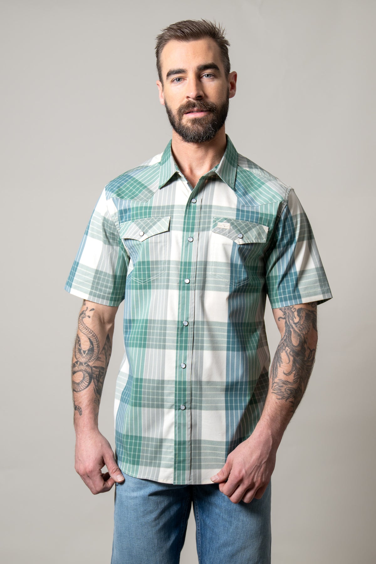 Kimes Ranch Chico short sleeve dress shirt in Green with a plaid pattern and two chest pockets