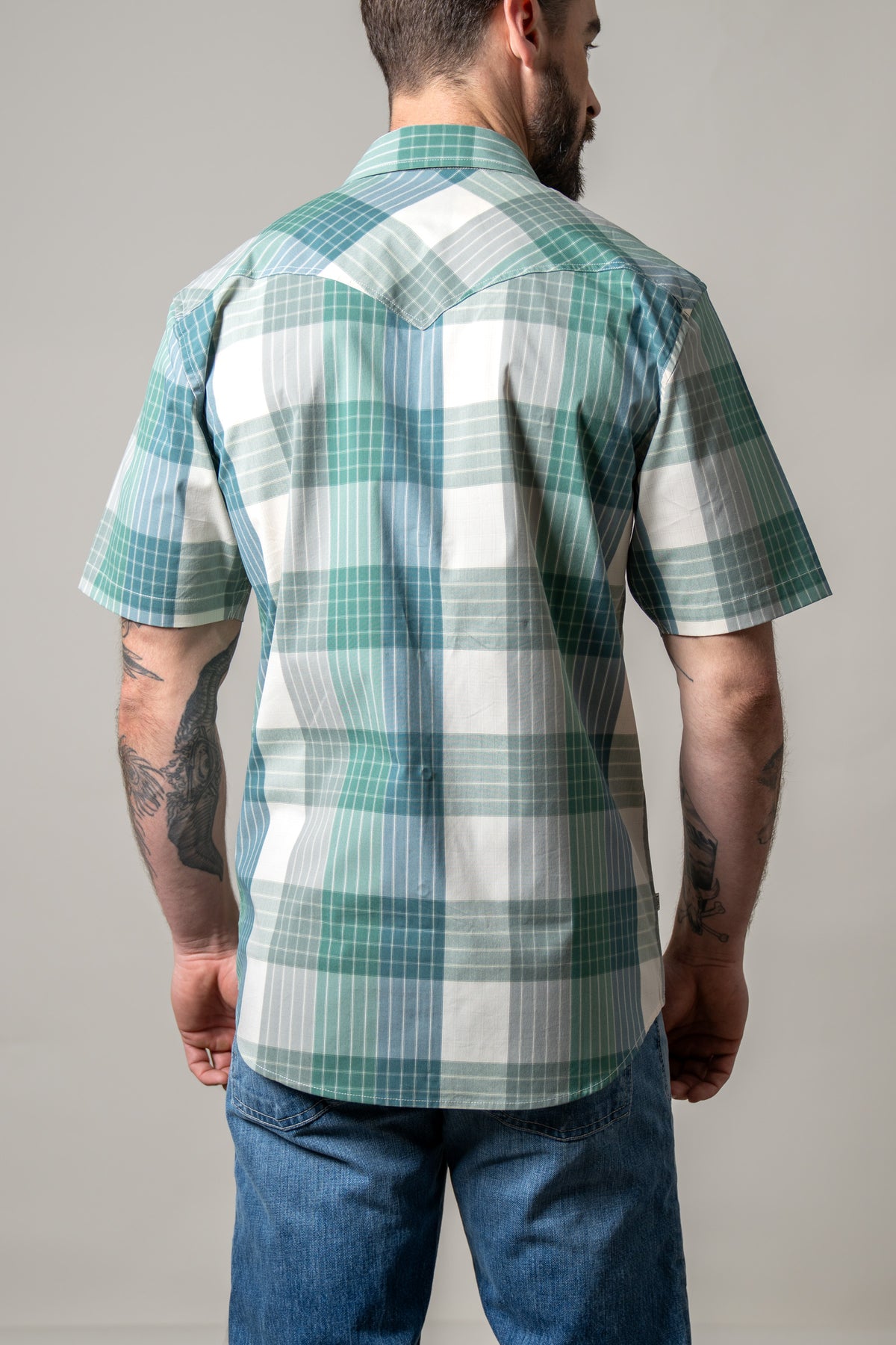 Kimes Ranch Chico dress shirt in Green, back view, with a plaid pattern and short sleeves