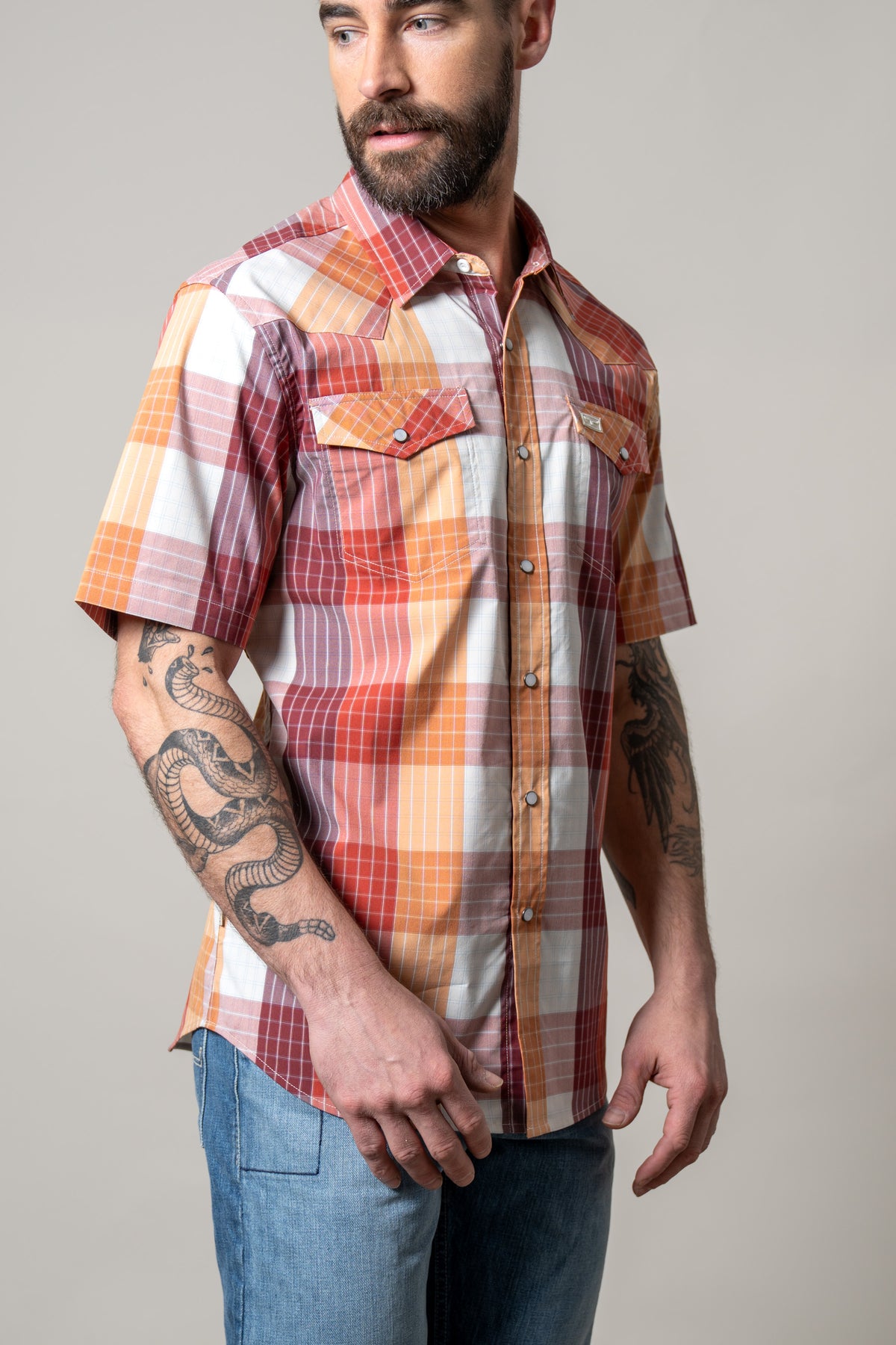 Kimes Ranch Chico short sleeve button-up dress shirt in Red with a multi-color plaid pattern and two chest pockets