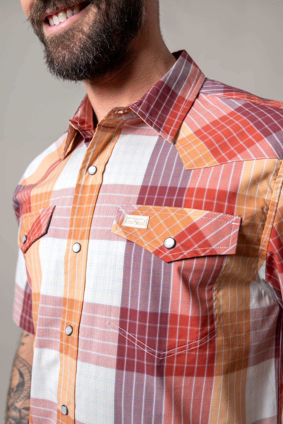 Kimes Ranch Chico dress shirt in Red, close-up, with a multi-color plaid pattern and snap-button chest pockets