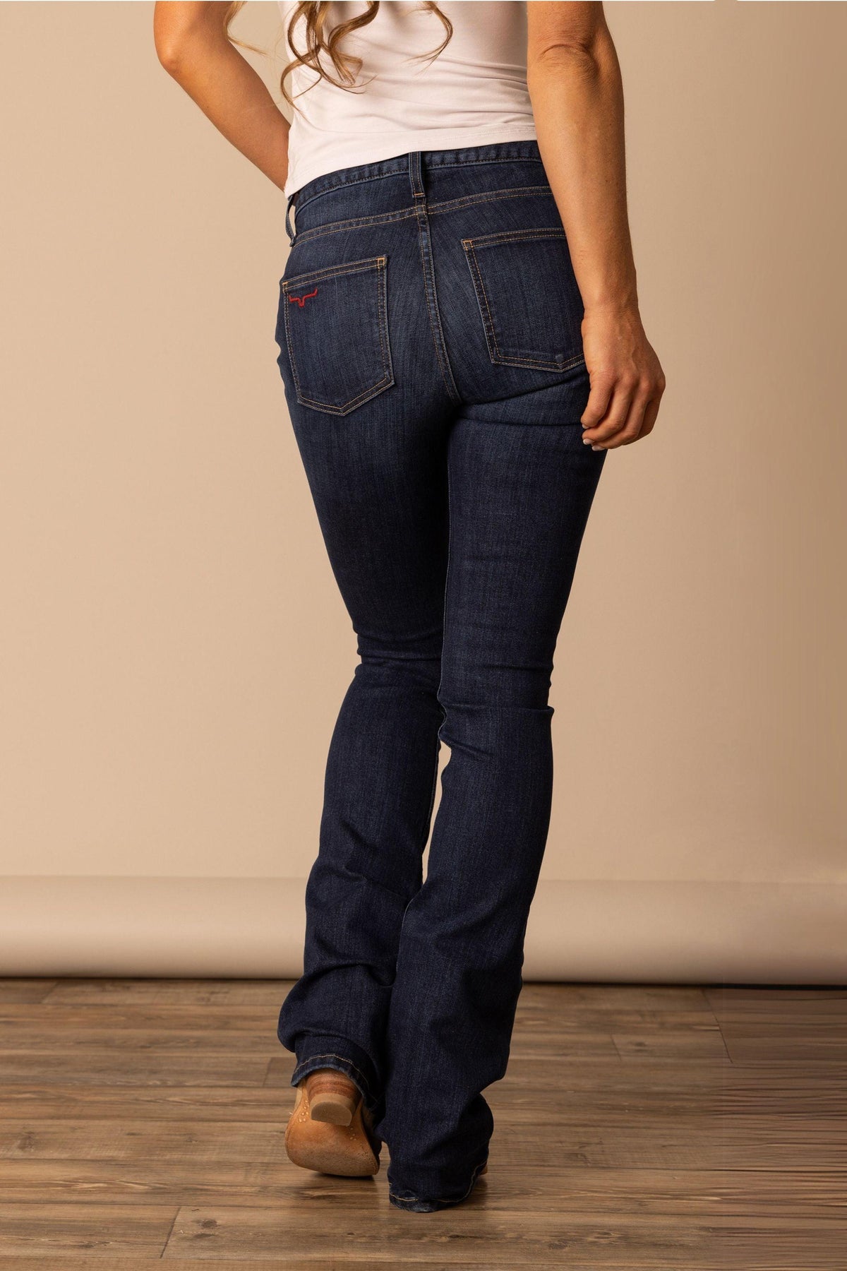 Kimes Ranch Chloe jeans in Dark Wash, back view, with back pockets and a red logo