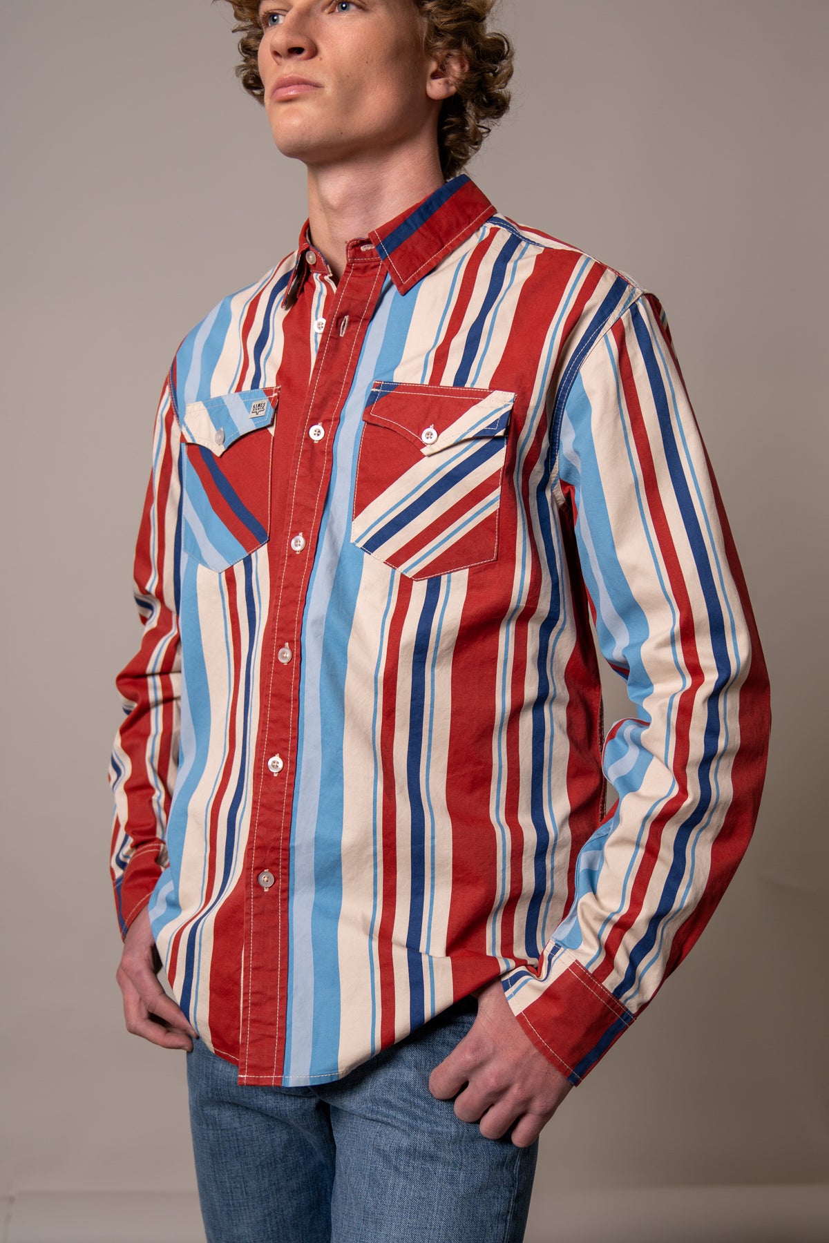 Kimes Ranch Clancy dress shirt in Brick Red with blue and white vertical stripes and two chest pockets