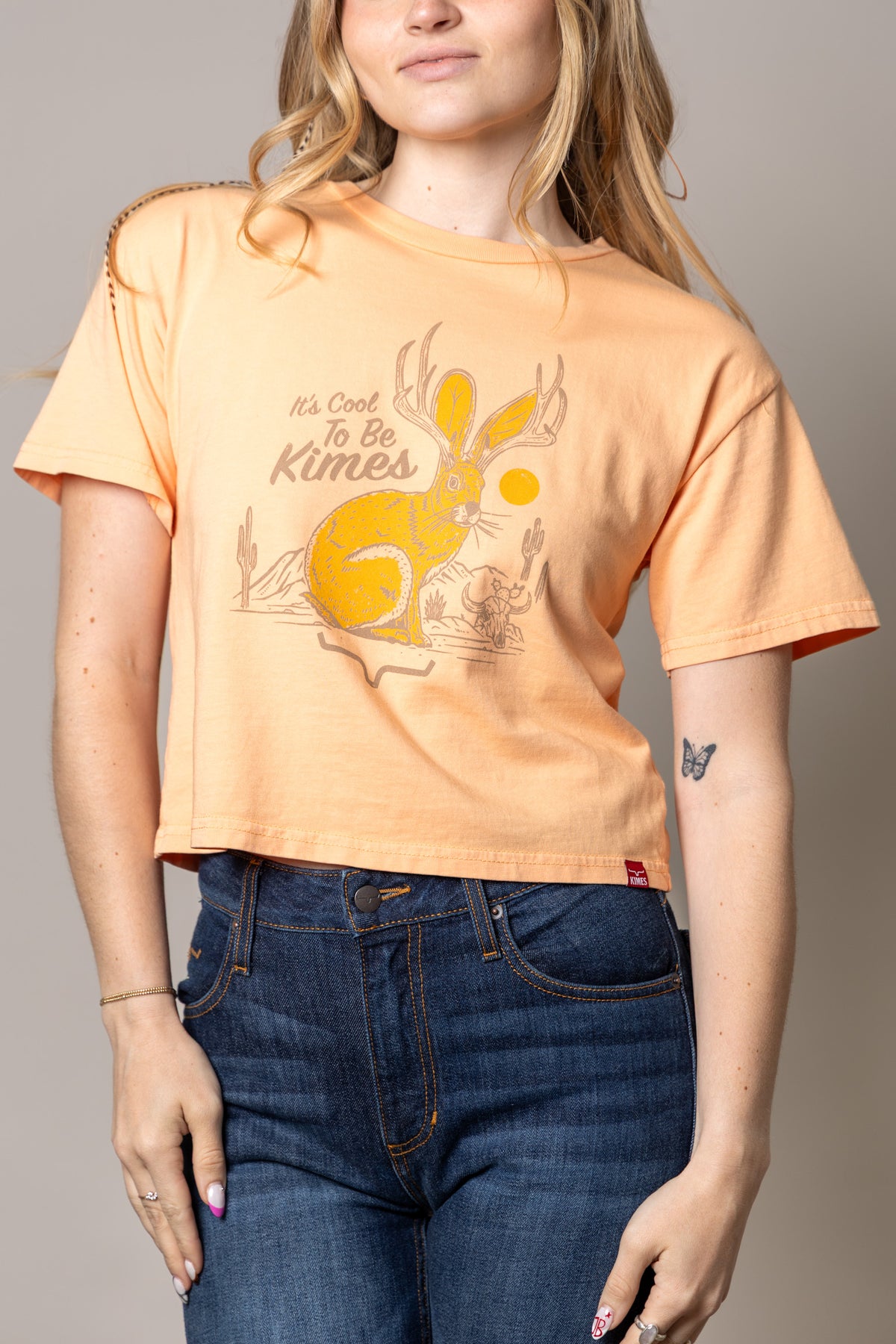 Kimes Ranch Cool Jack shirt in Peach with a graphic of a jackrabbit with antlers and the text It's Cool To Be Kimes