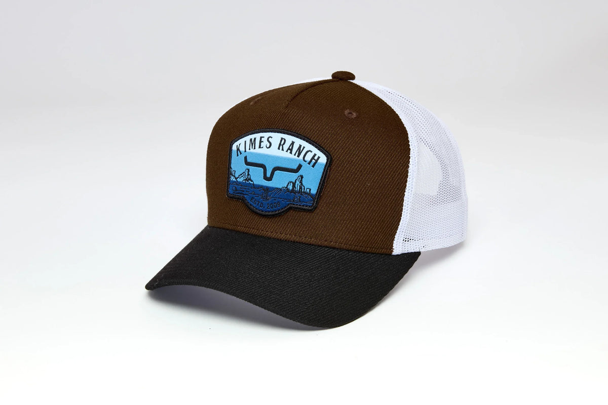 Kimes Ranch Crimson trucker hat in Brown with white mesh back and black brim, featuring the Kimes Ranch logo patch