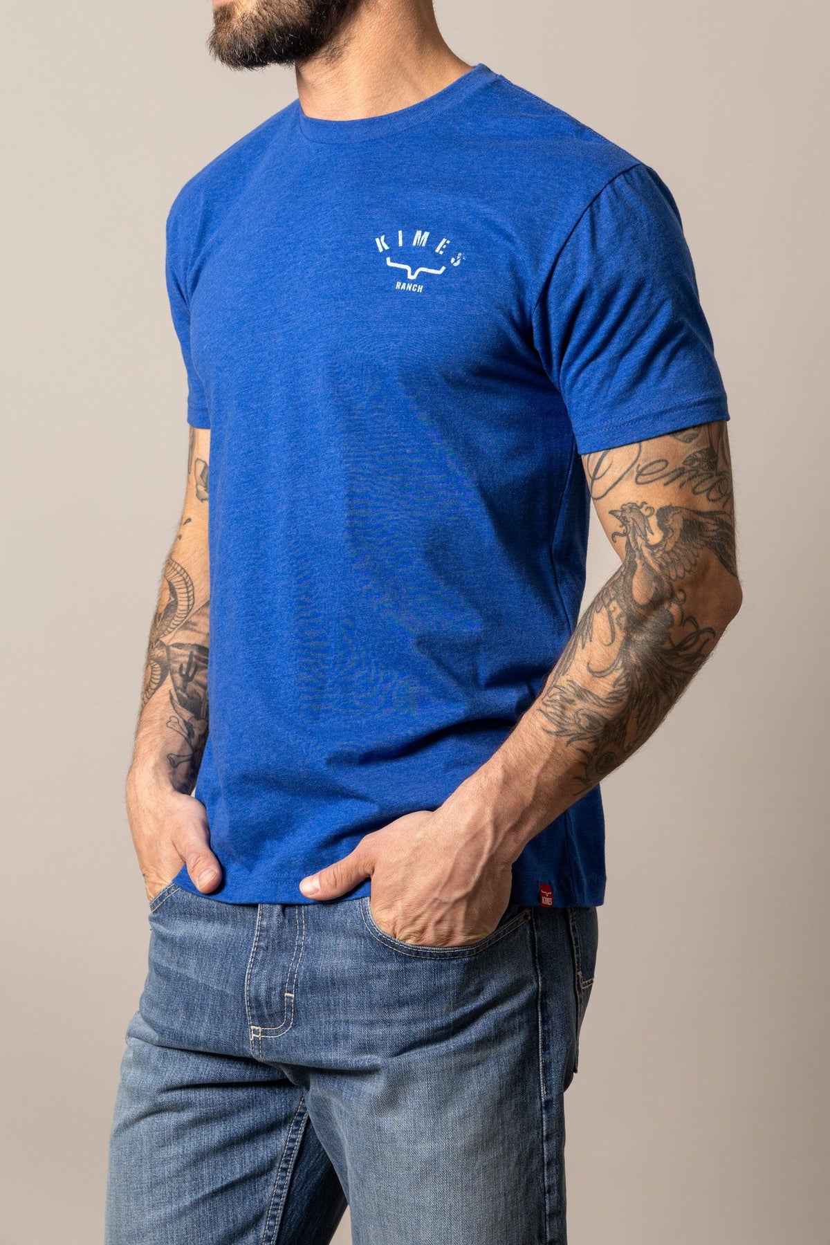 Kimes Ranch Cut Through shirt in Marine Blue, side view, with a chest logo and short sleeves