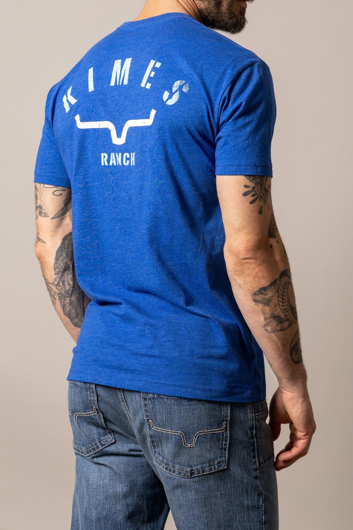Kimes Ranch Cut Through shirt in Marine Blue, back view, with a back graphic featuring the Kimes Ranch logo and text