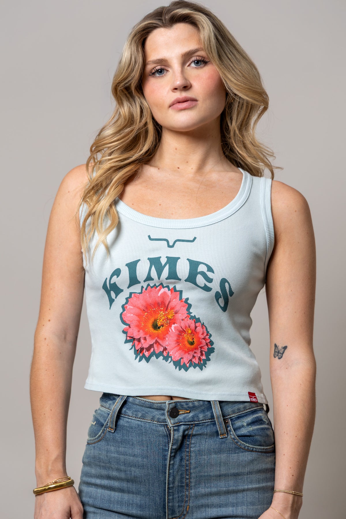 Kimes Ranch Desert Rose Ice Blue ribbed tank top with a graphic of two pink flowers and the brand name